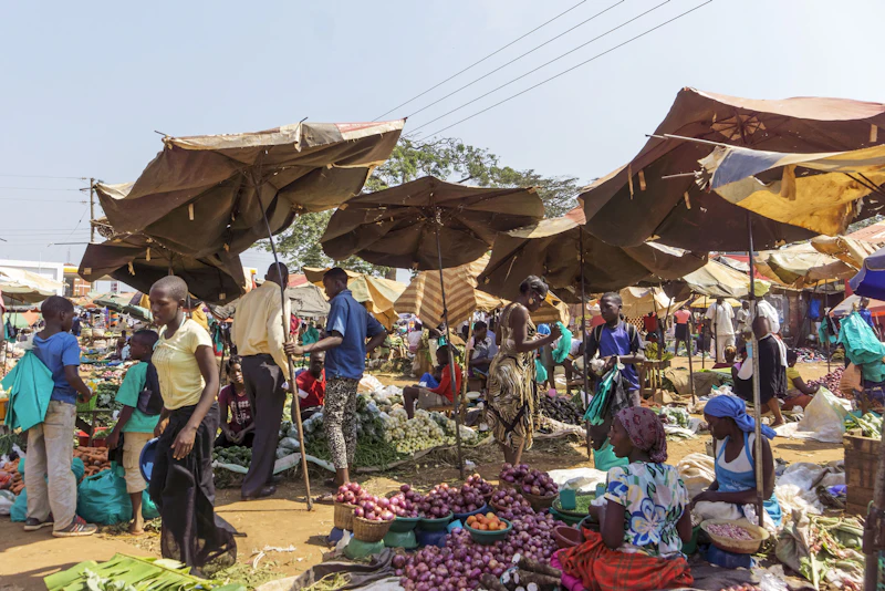 Traders and shoppers at a busy market stall