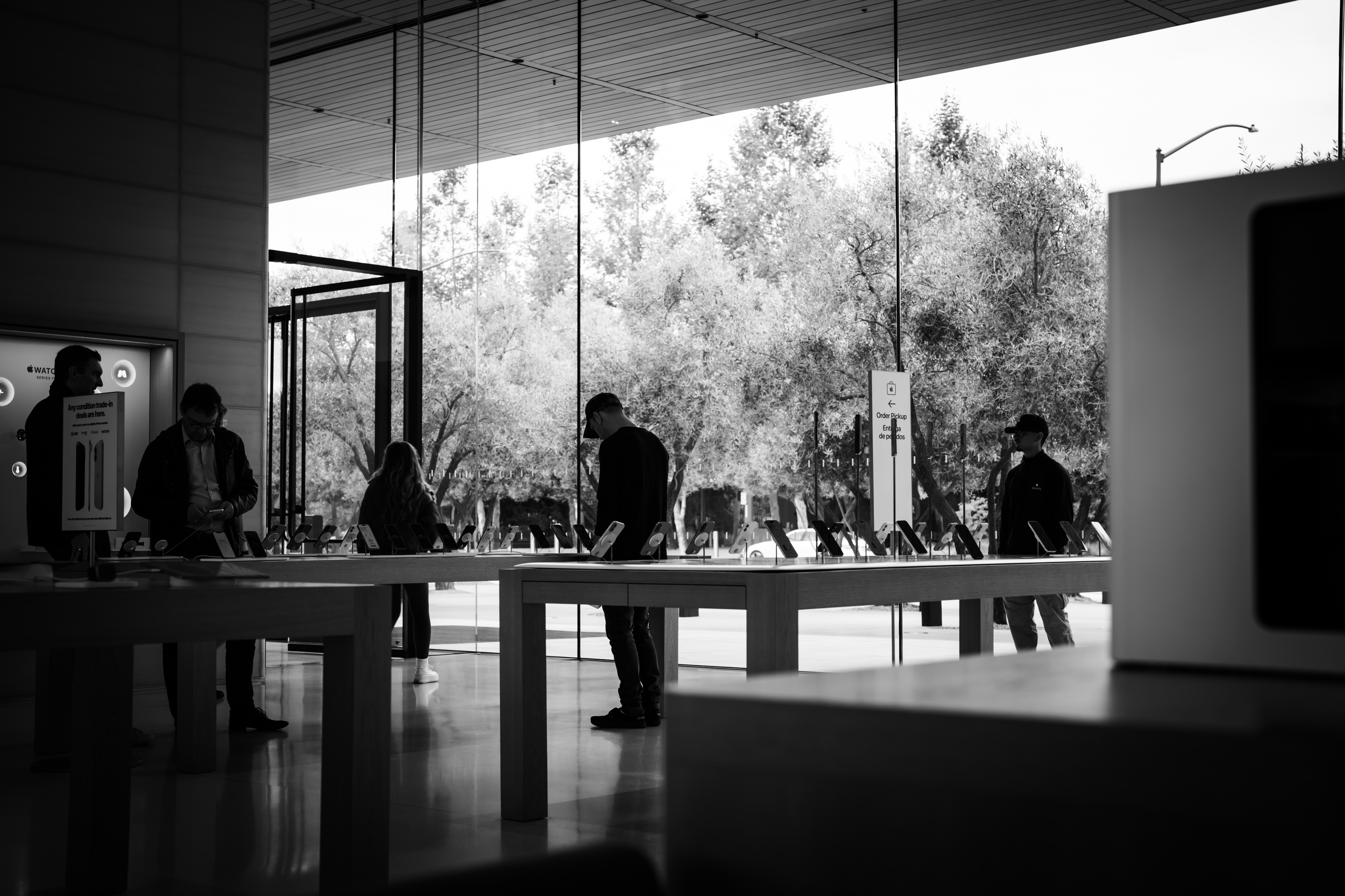 People browsing in a modern store with large windows.