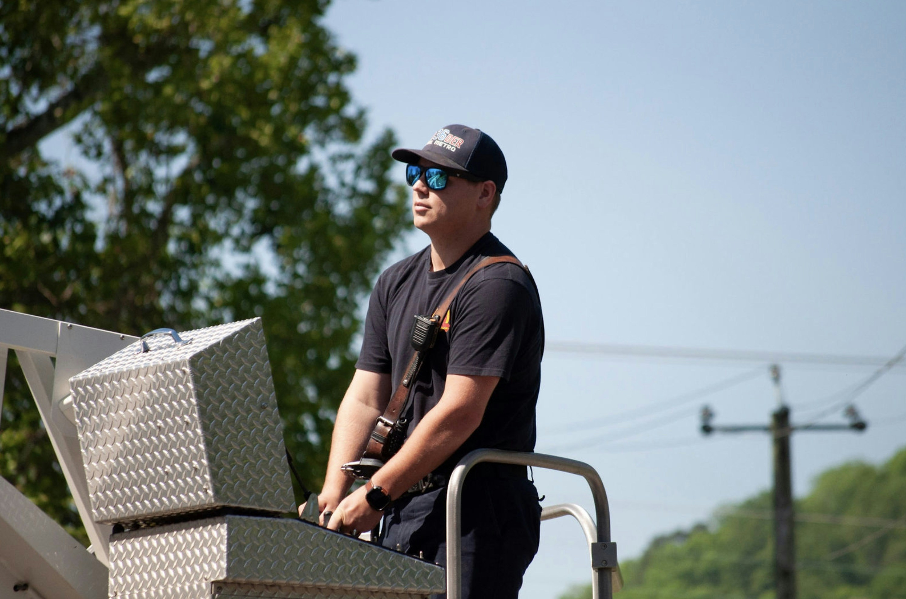 Man in sunglasses on a ladder truck