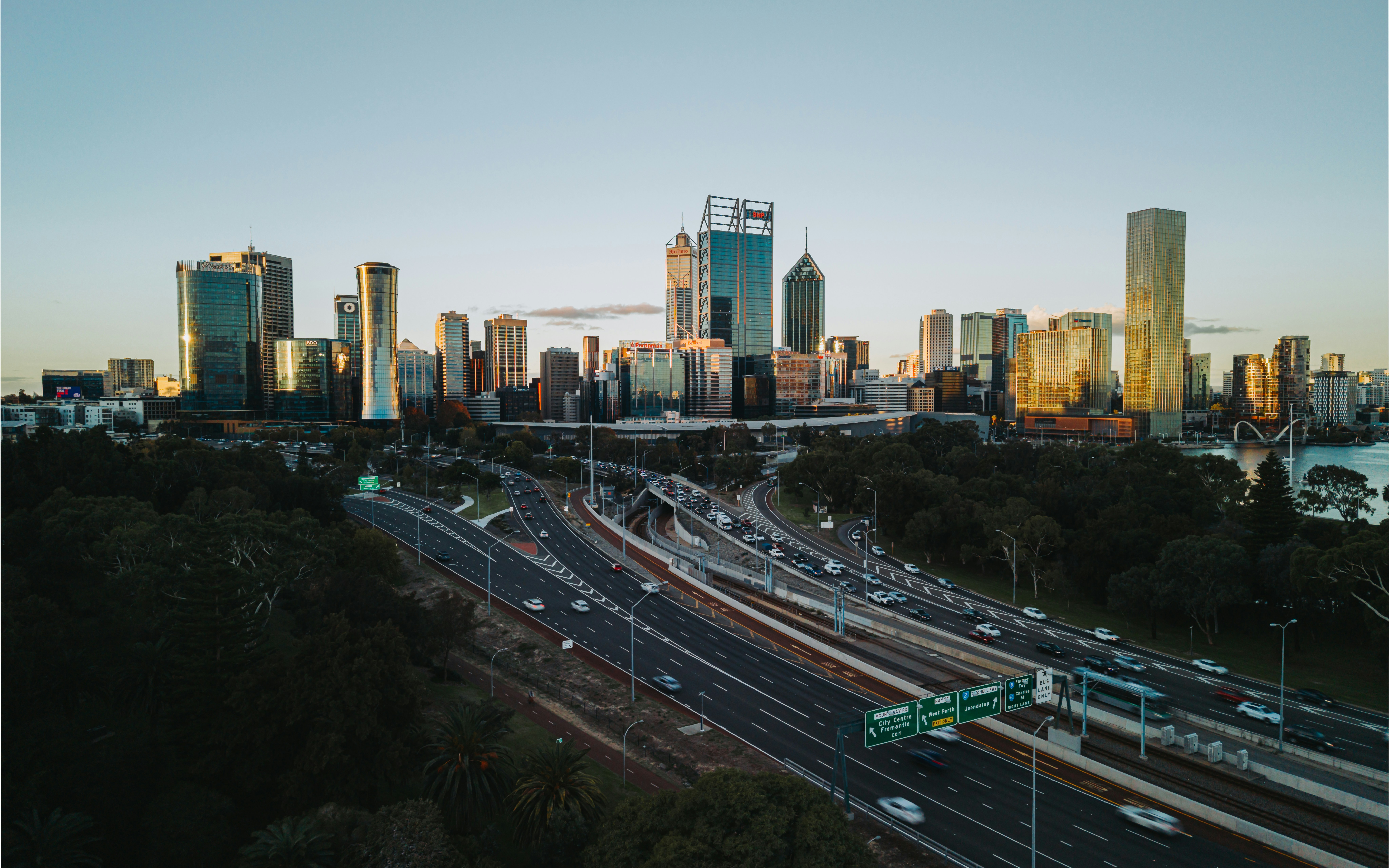 City skyline with busy highway at sunset