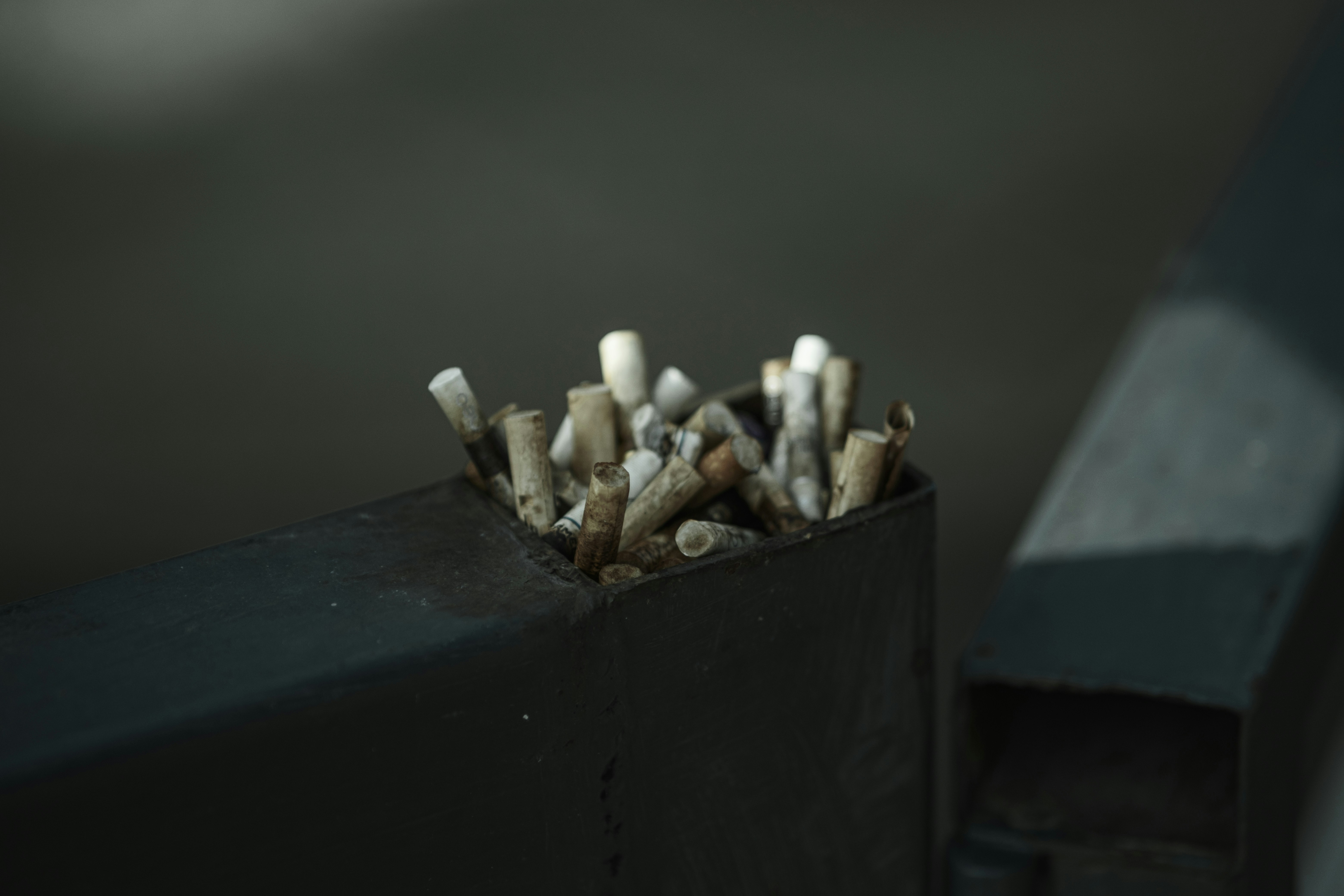 Ashtray overflowing with cigarette butts
