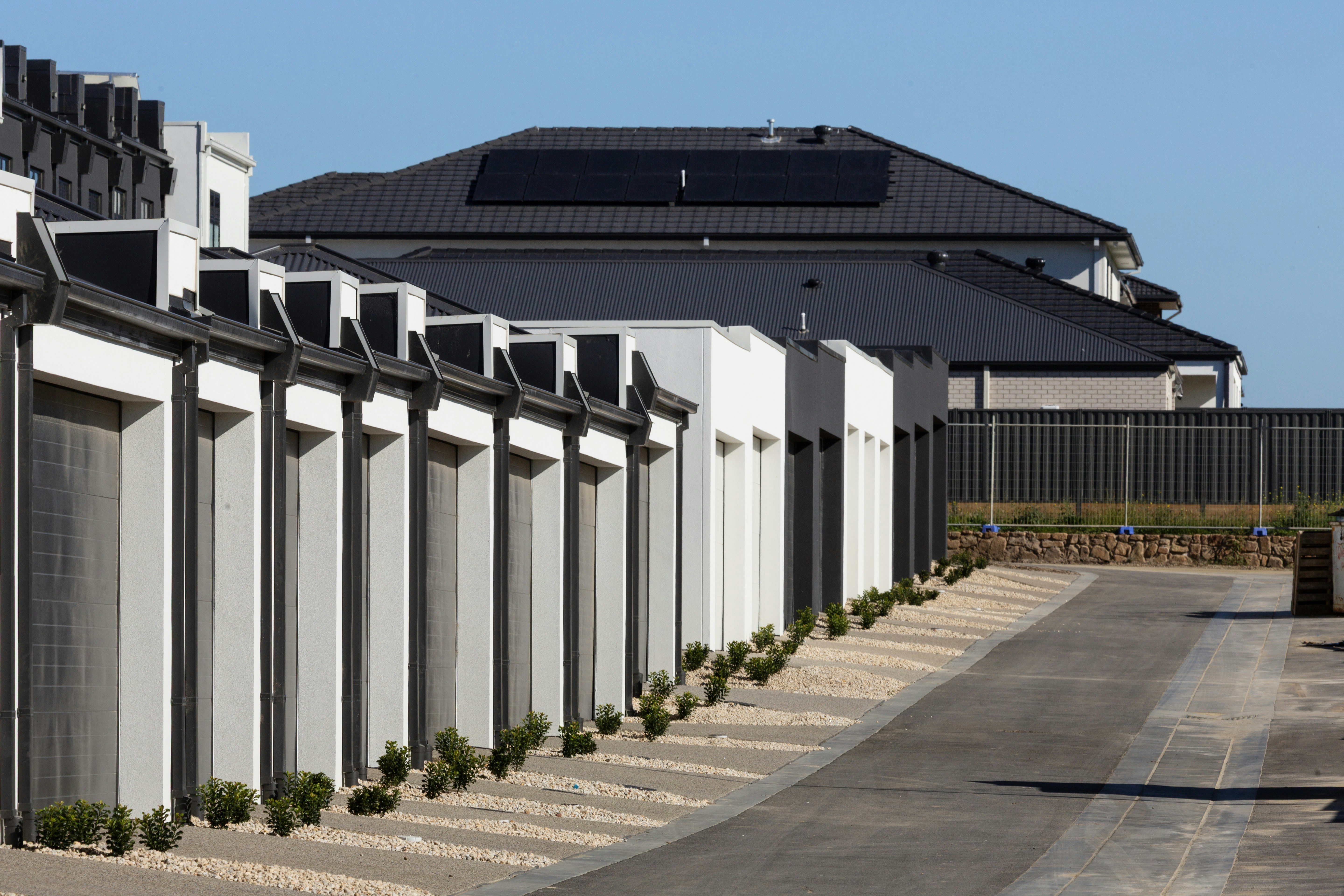 Modern townhouses with garages and solar panels