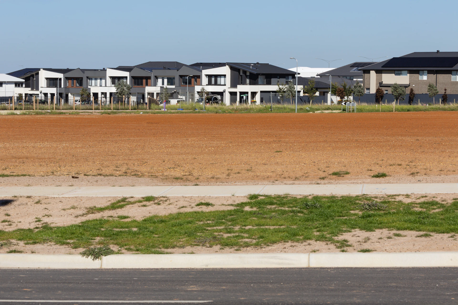 Modern houses under a clear blue sky.