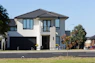 Modern two-story house with a dark garage door.