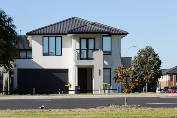 Modern two-story house with a dark garage door.