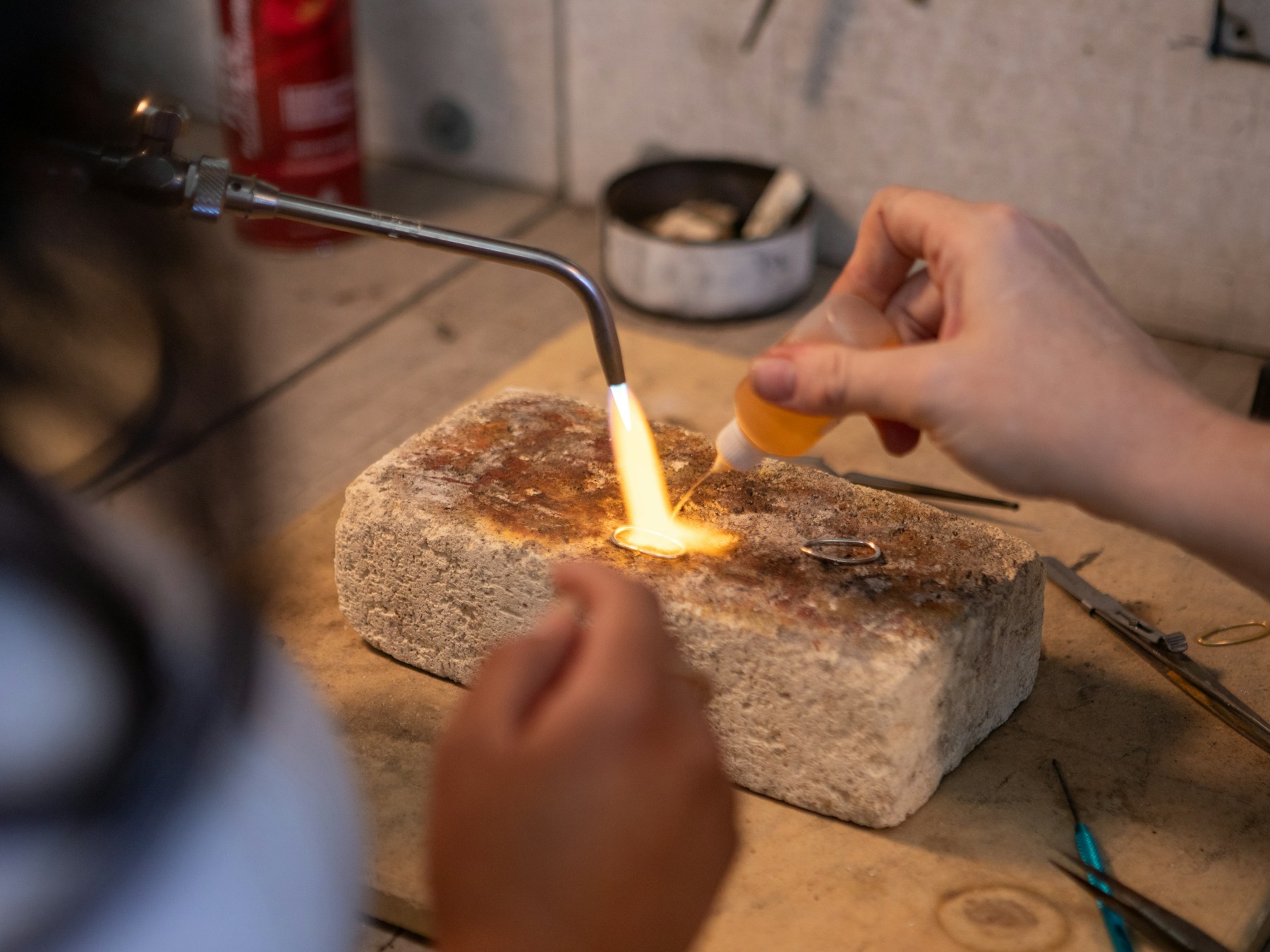 Master goldsmith at the bench casting a fine 18k gold piece