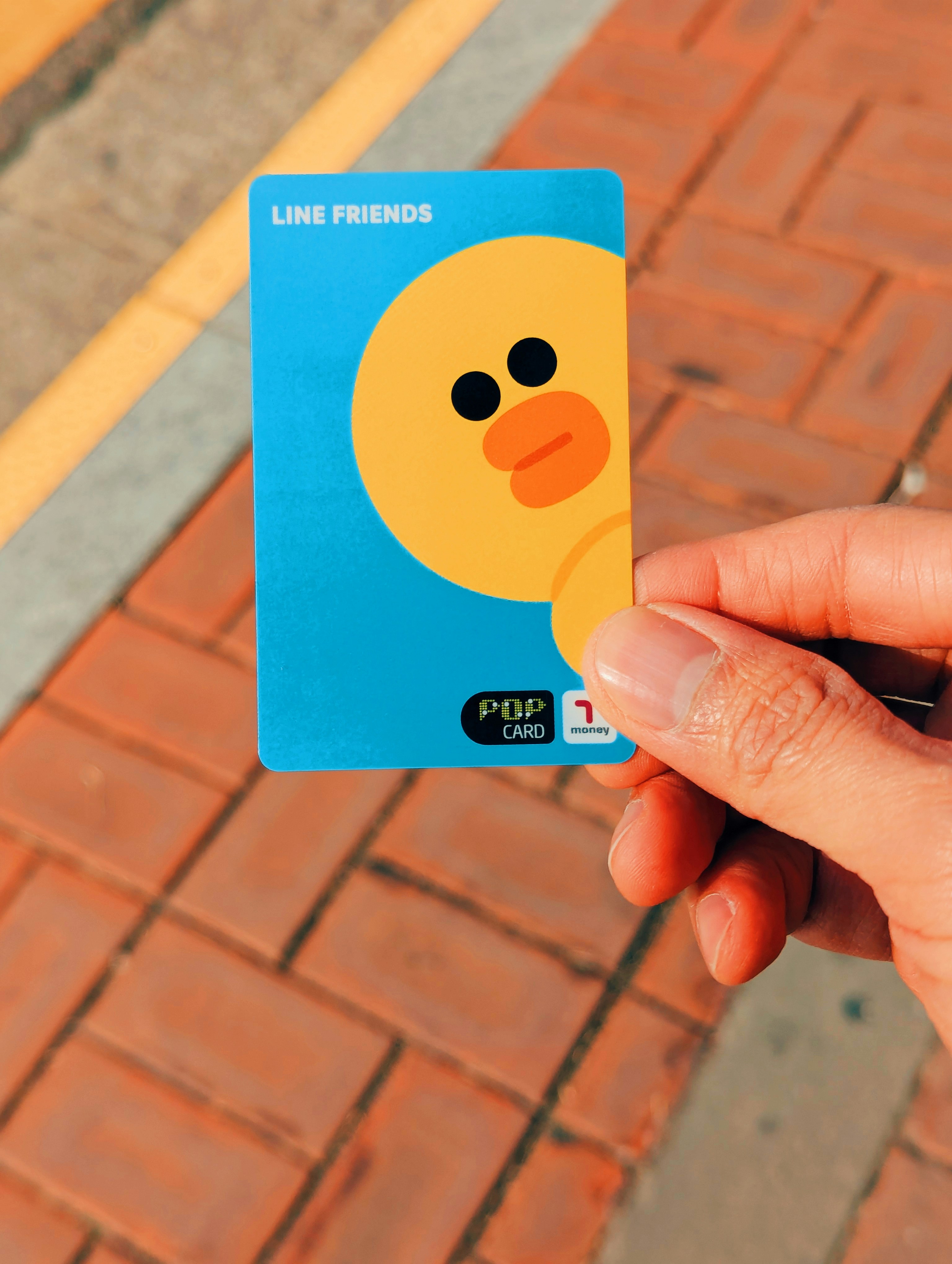 Hand holding a blue line friends sally pop card