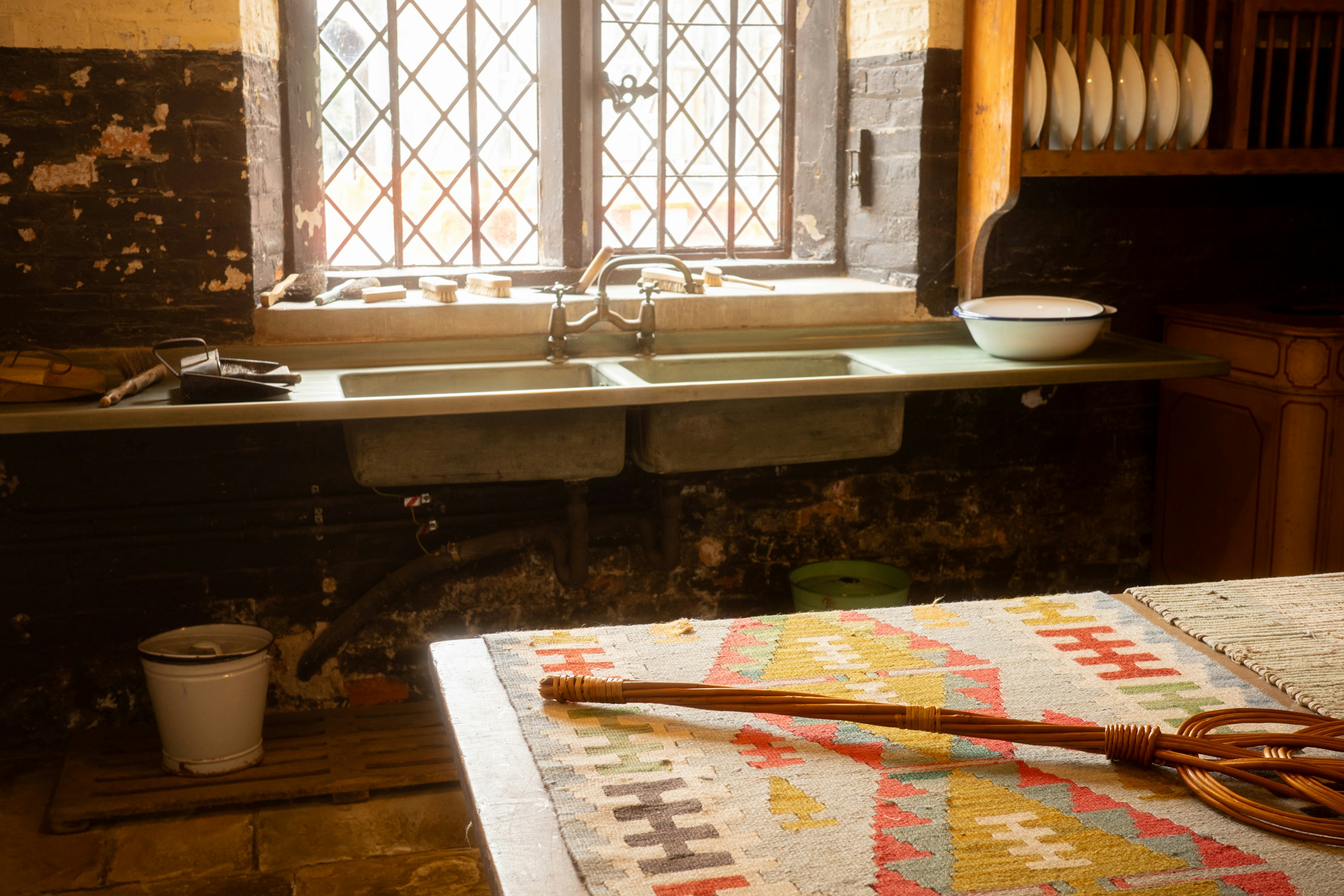Rustic kitchen with double sink and patterned rug