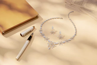 Diamond necklace and earrings with pen and pen