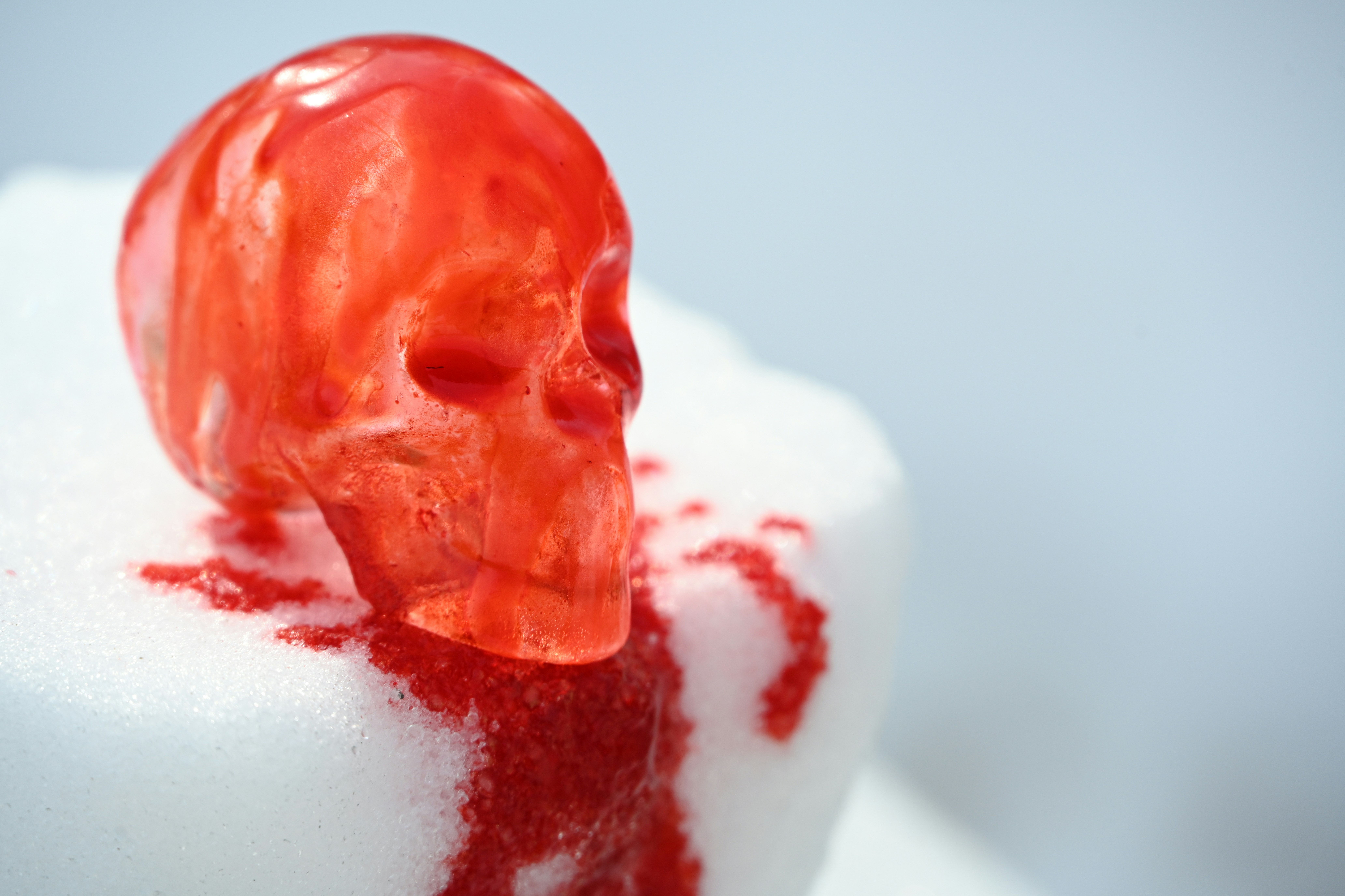 A red skull candy with dripping red syrup.