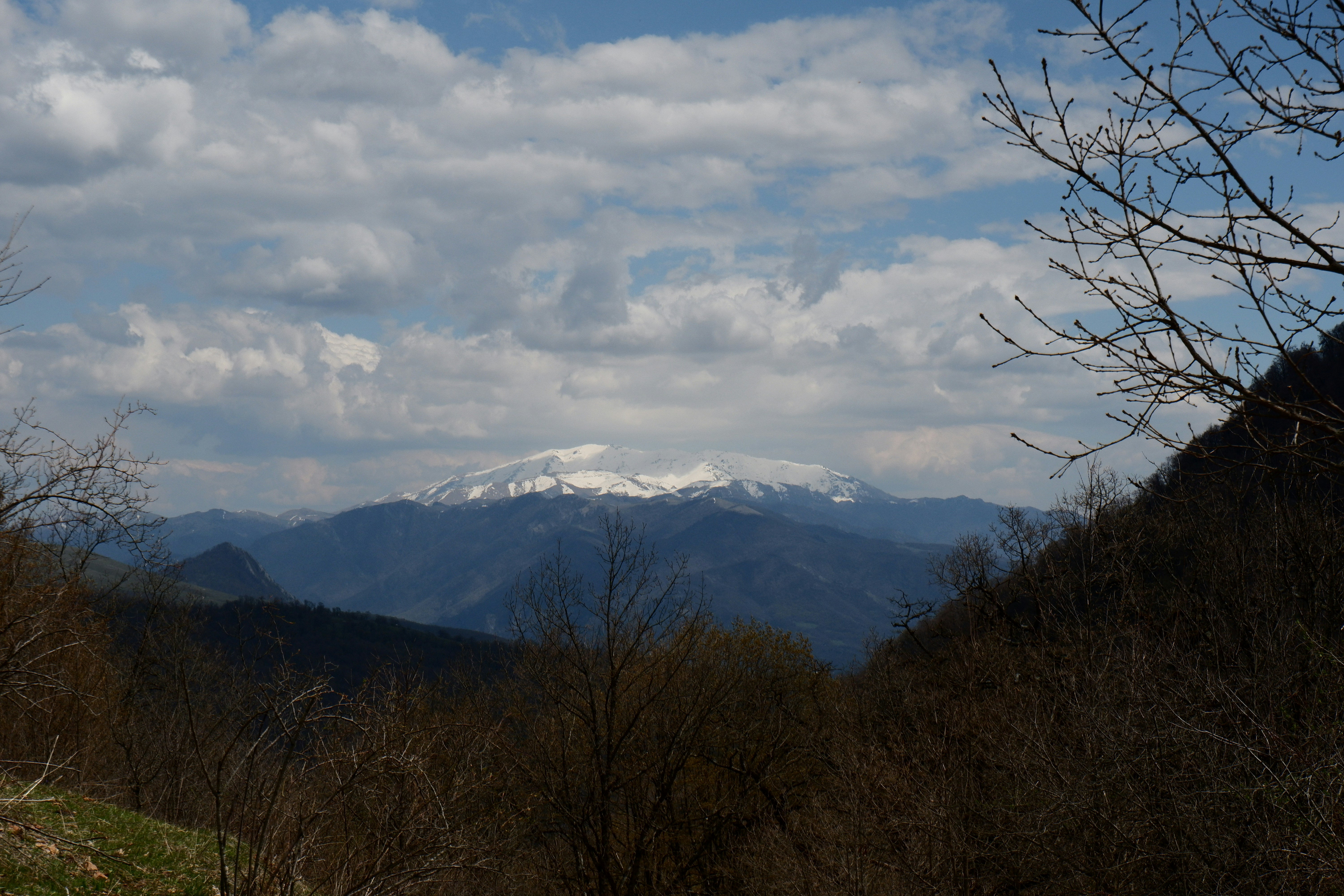 Snow-capped mountains under a cloudy sky