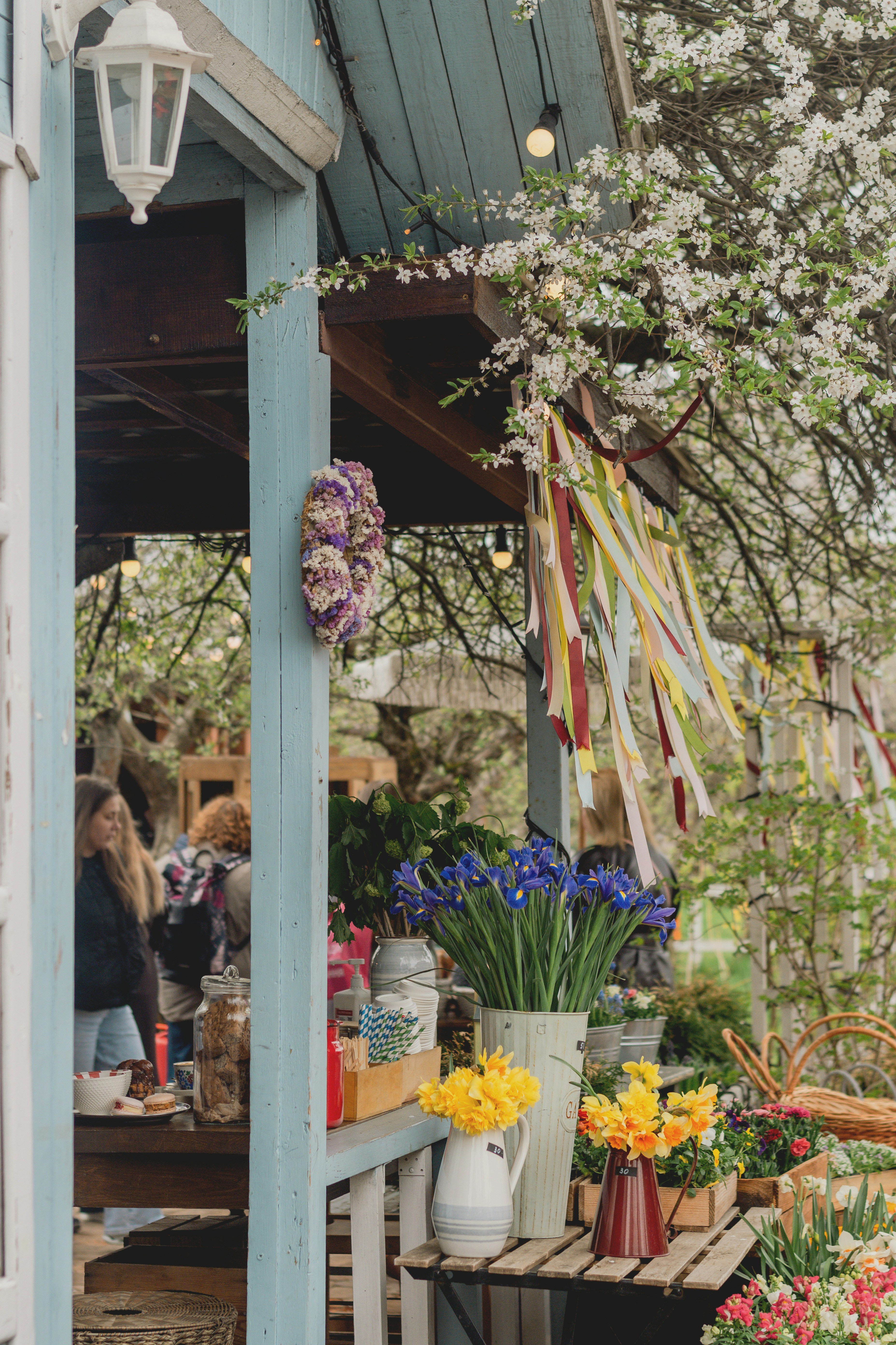 Outdoor flower stall with colorful blooms and ribbons