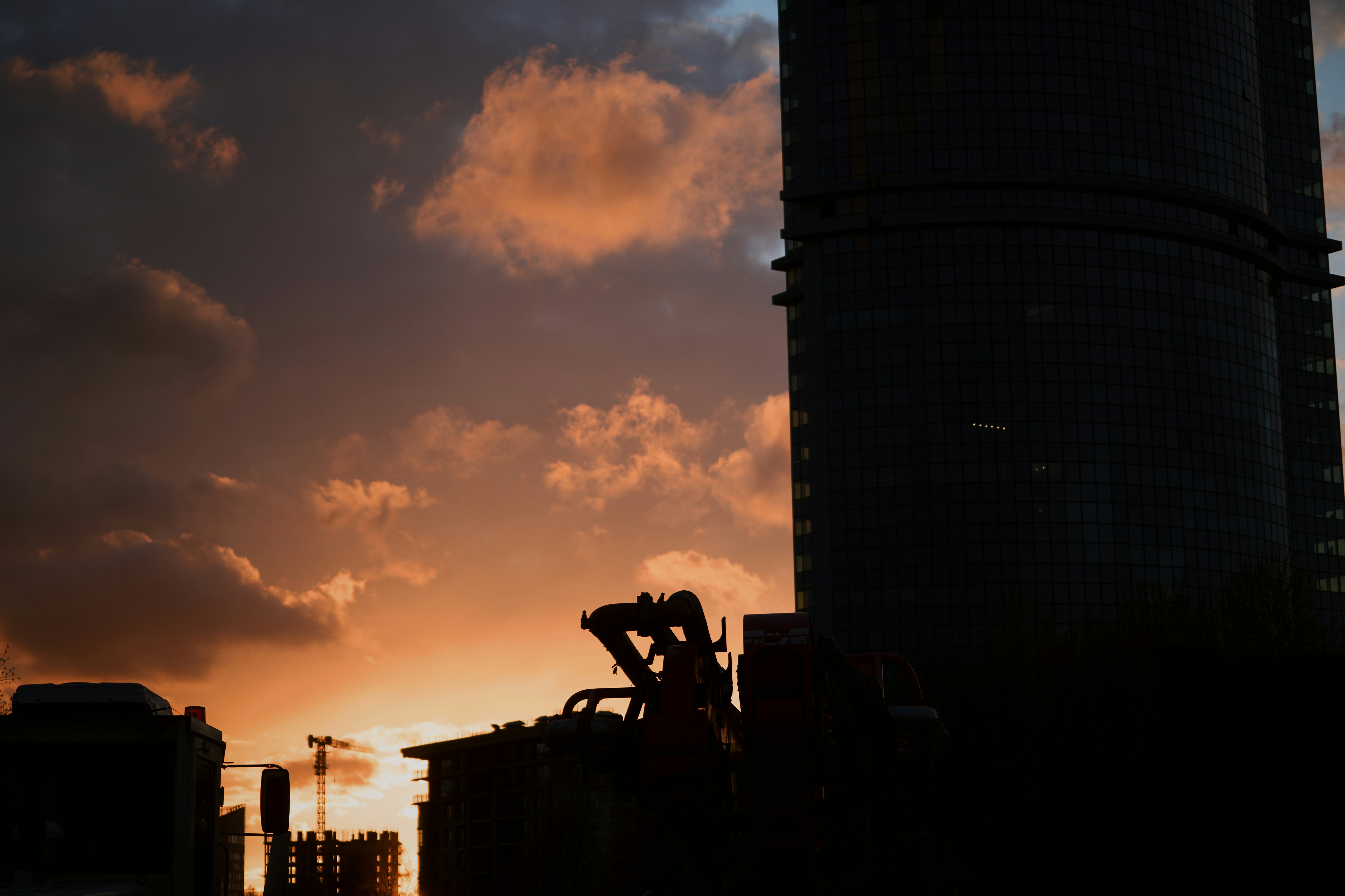 Skyscraper silhouetted against a dramatic sunset sky