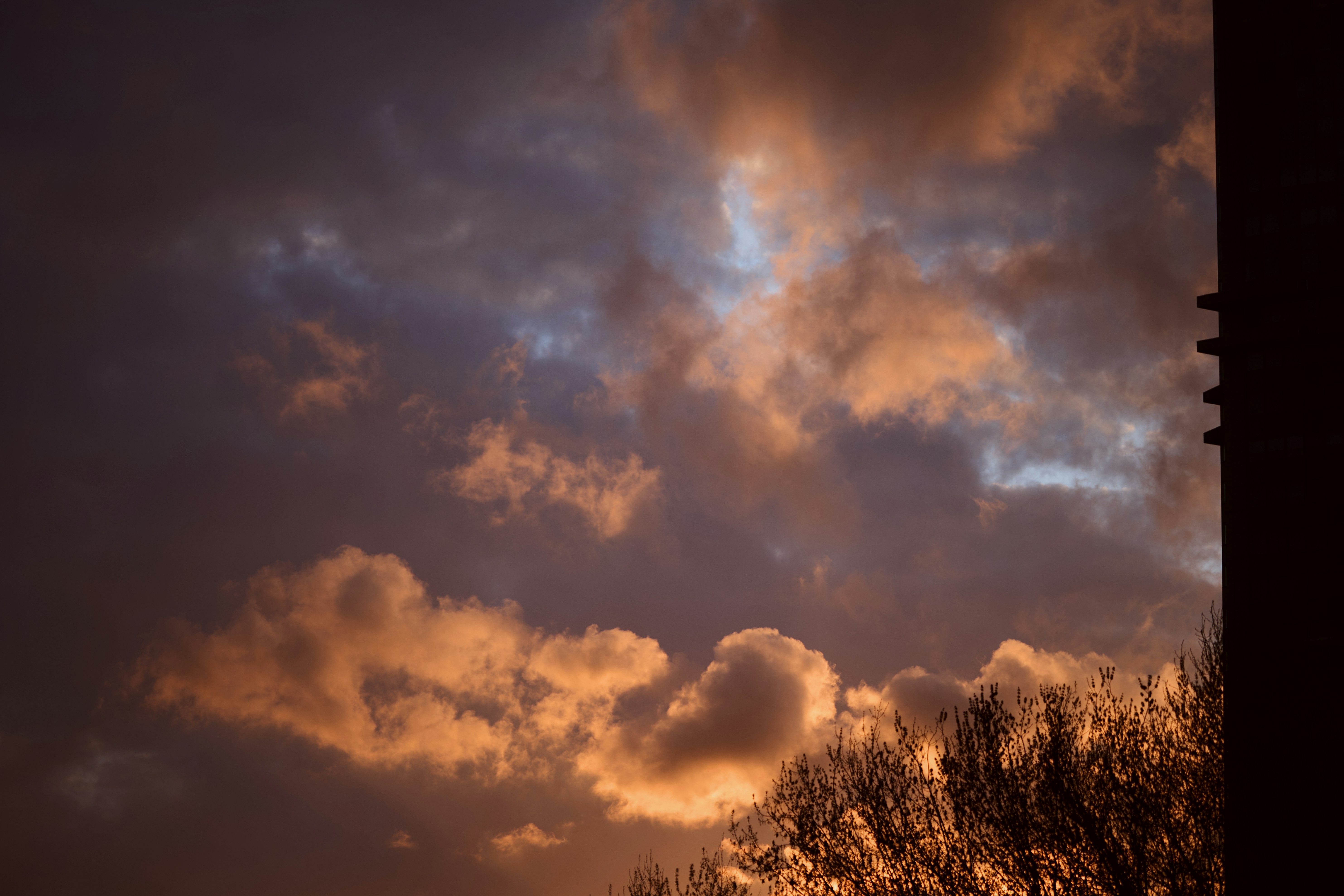 Dramatic sunset clouds glow with warm orange light.