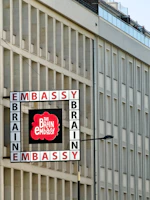 Embassy brain building exterior with a sign.