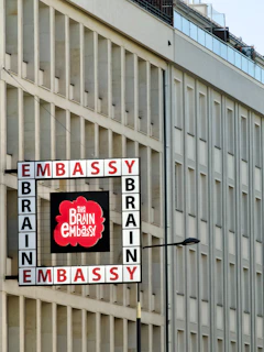 Embassy brain building exterior with a sign.