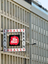 Embassy brain building exterior with a sign.