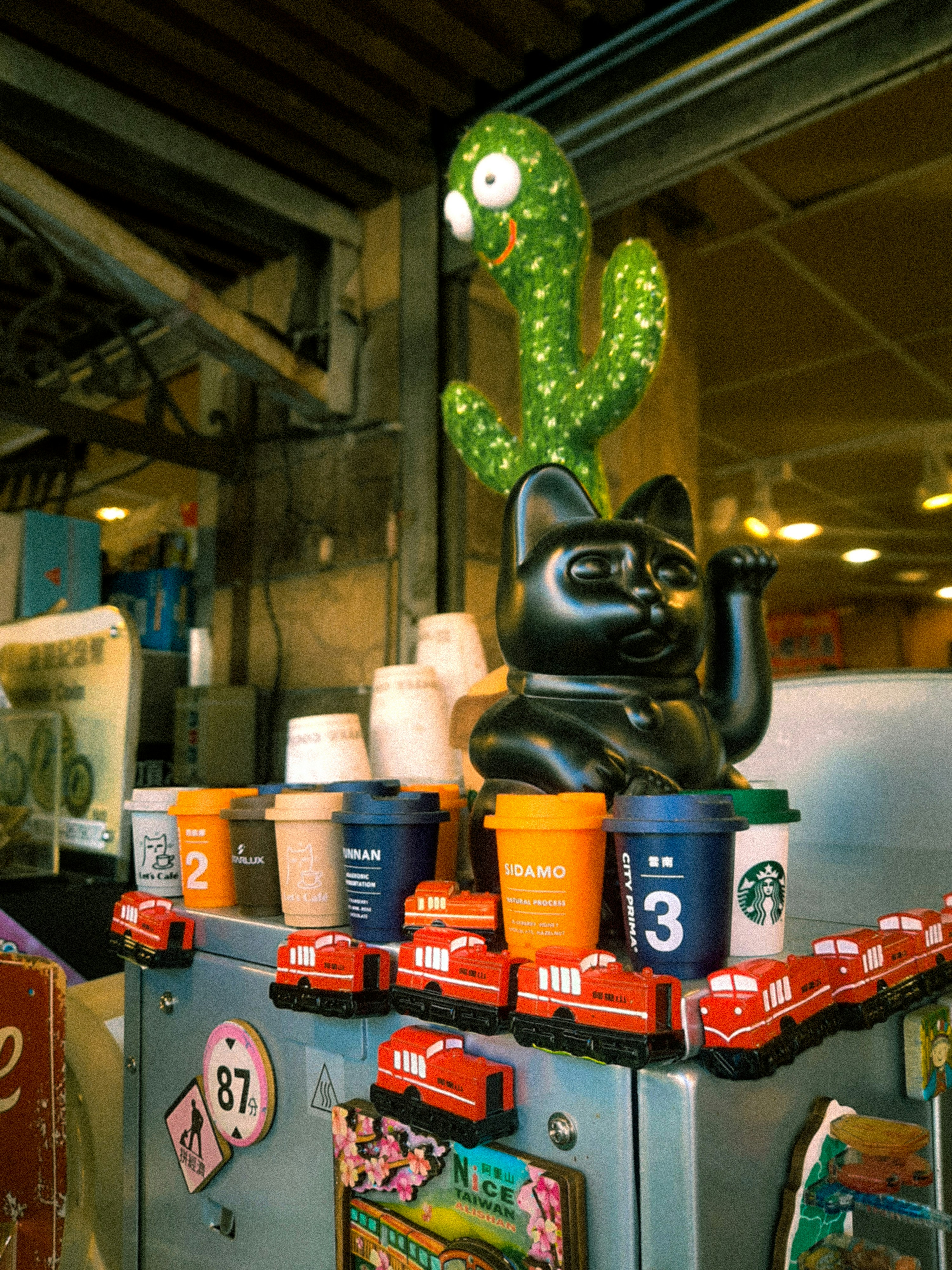 Black cat figure with cactus and coffee cups