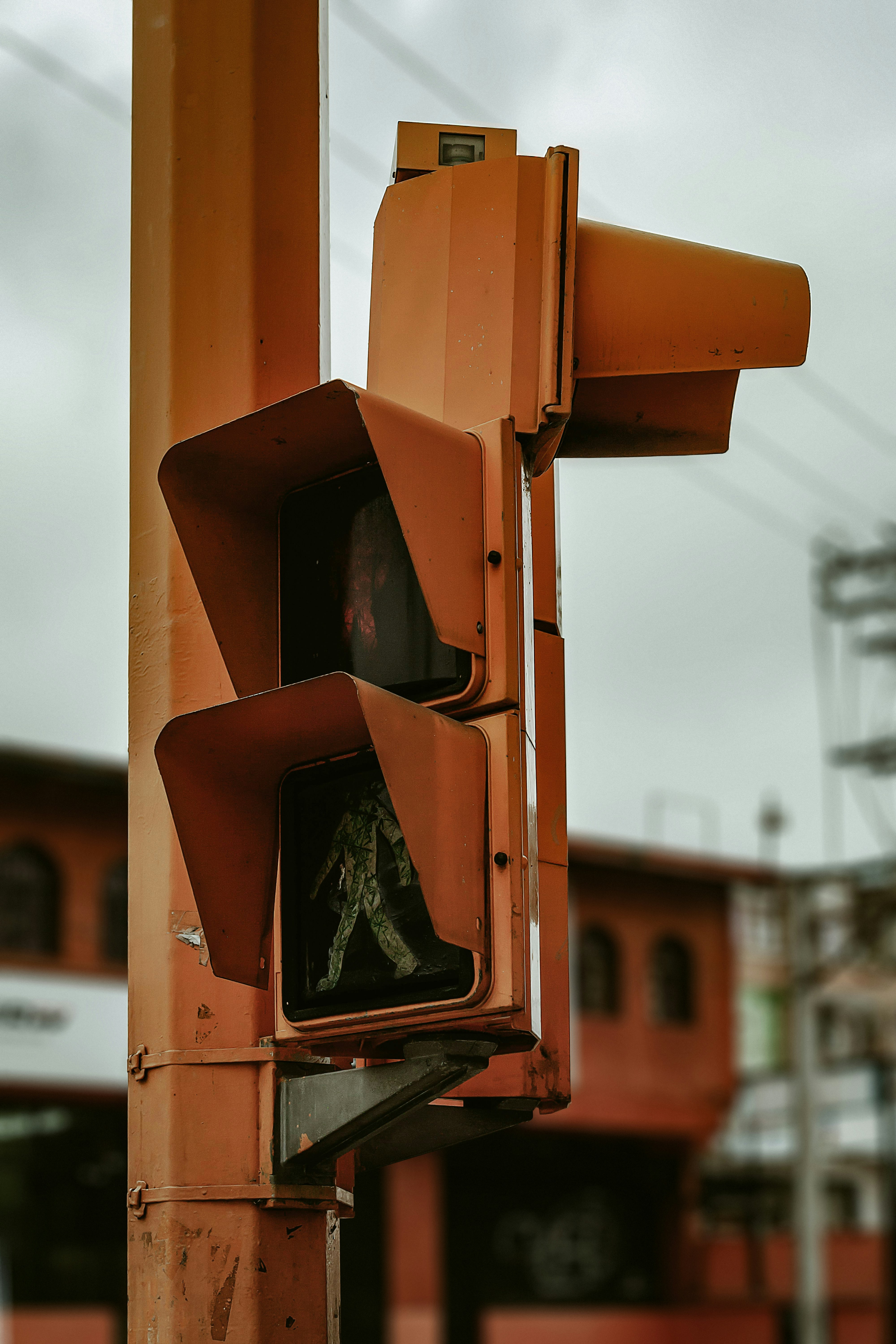 Orange traffic signal with pedestrian crossing light