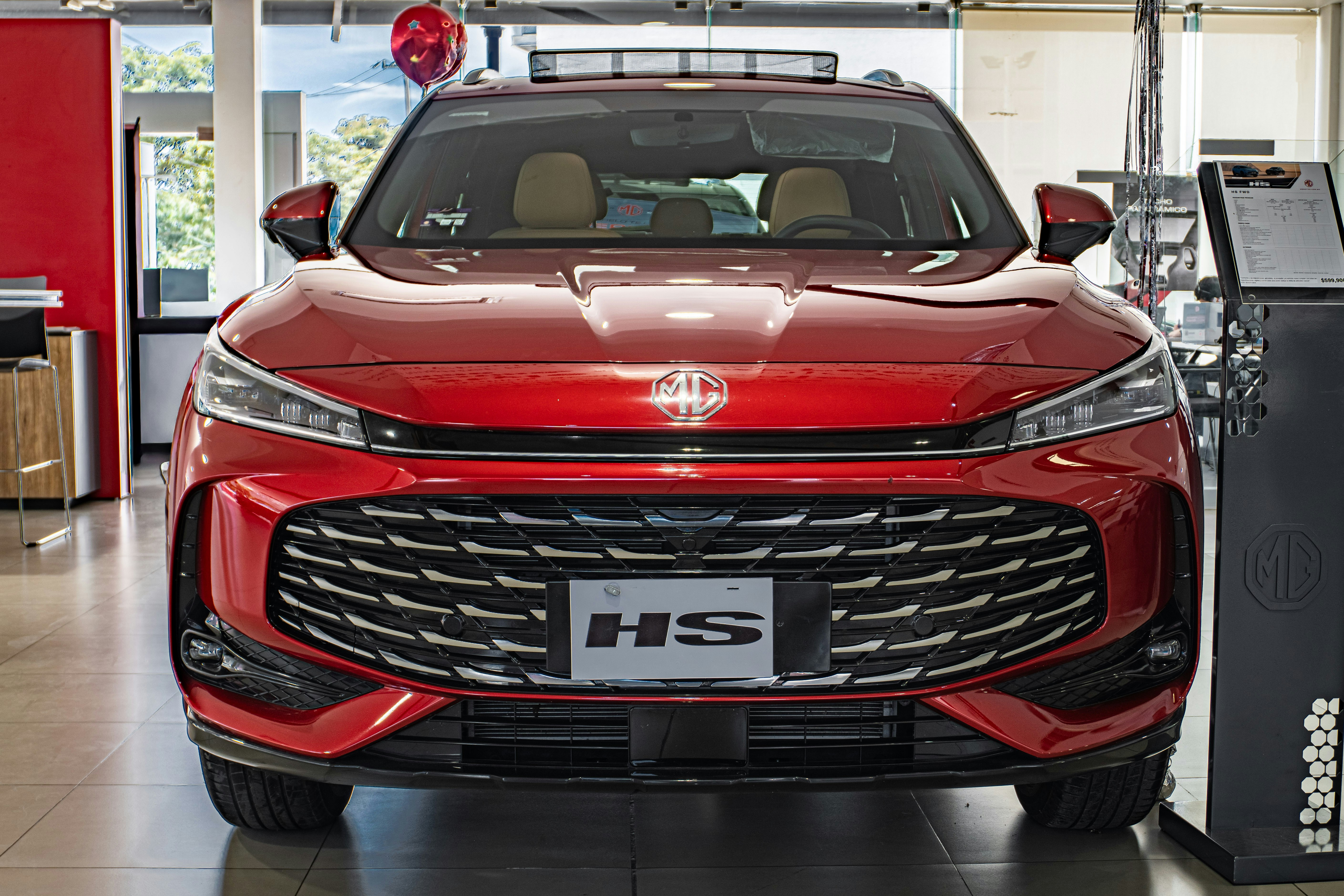 Red car with a large grille and headlights