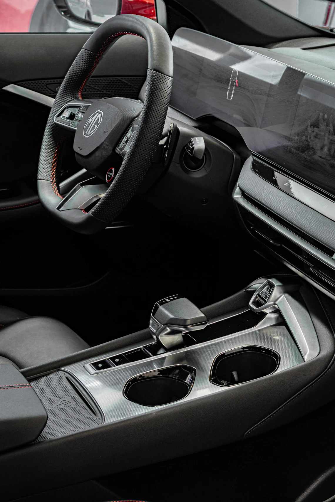 Modern automotive interior with steering wheel, dashboard, and center console