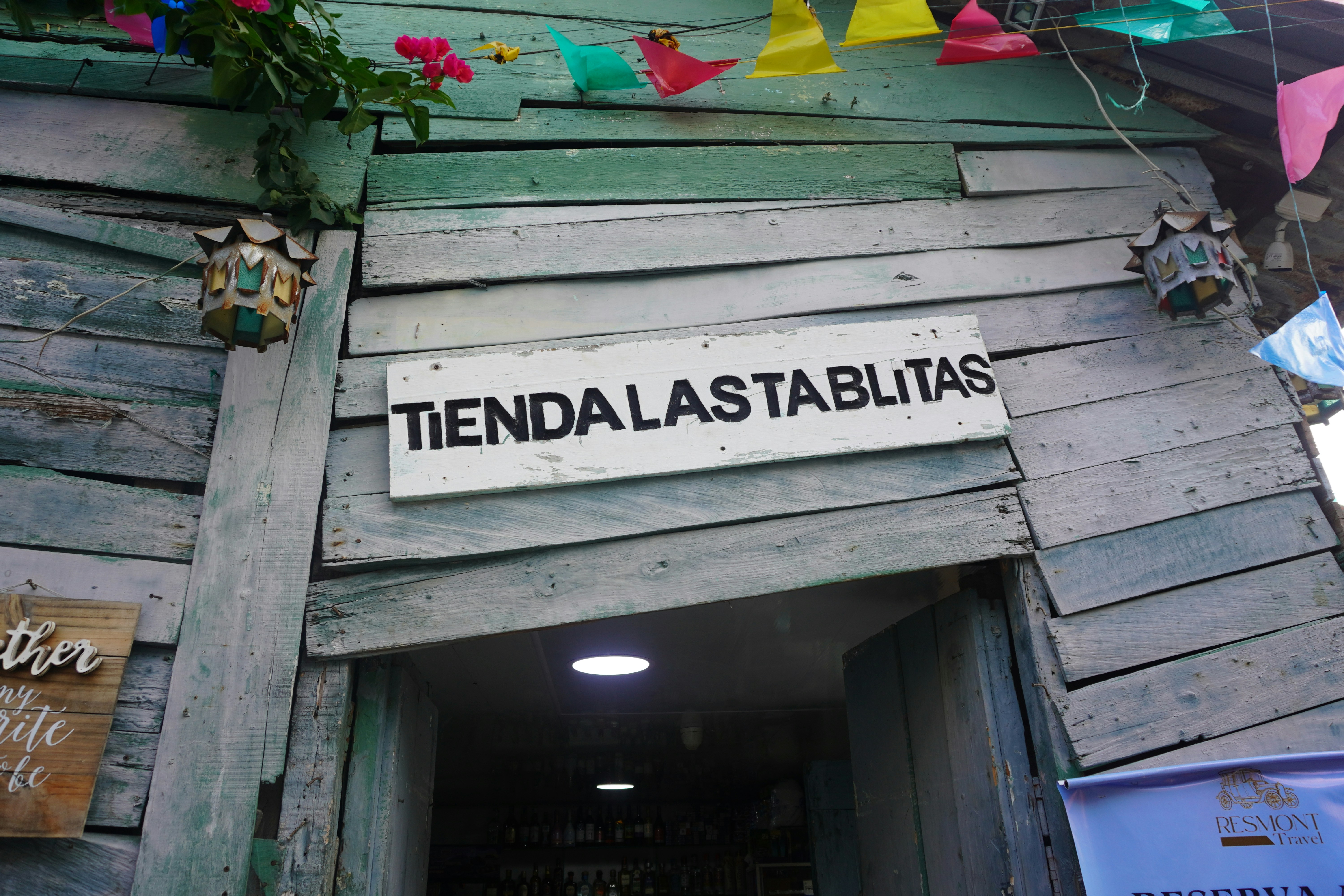 Rustic wooden shop entrance with sign tiendalastablitas