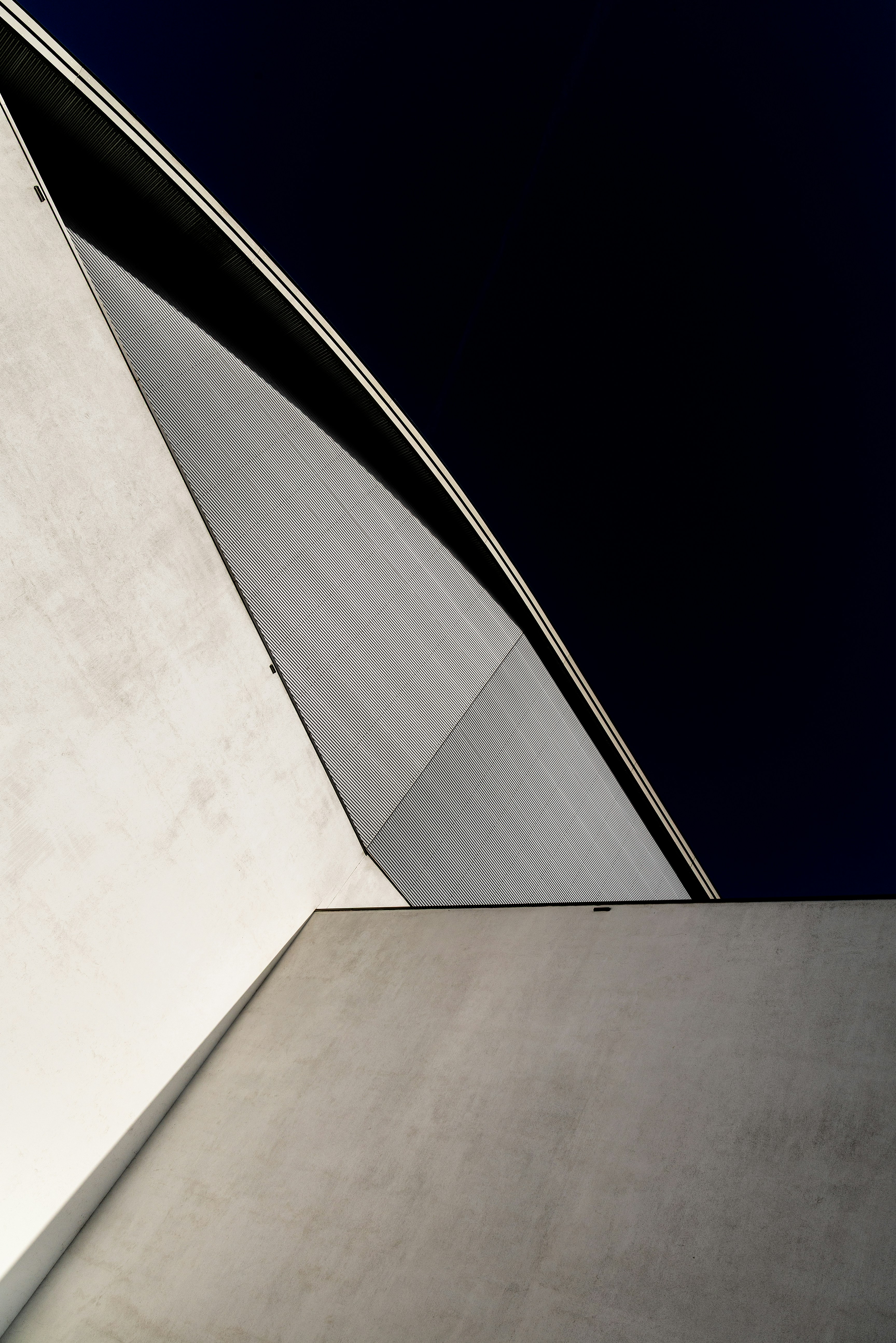 Abstract architectural shapes against a dark sky