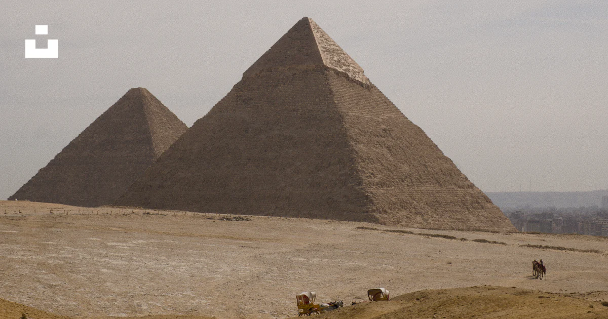 Pyramid Visual Sign The great pyramids of giza under a hazy sky - Free Photo on Unsplash