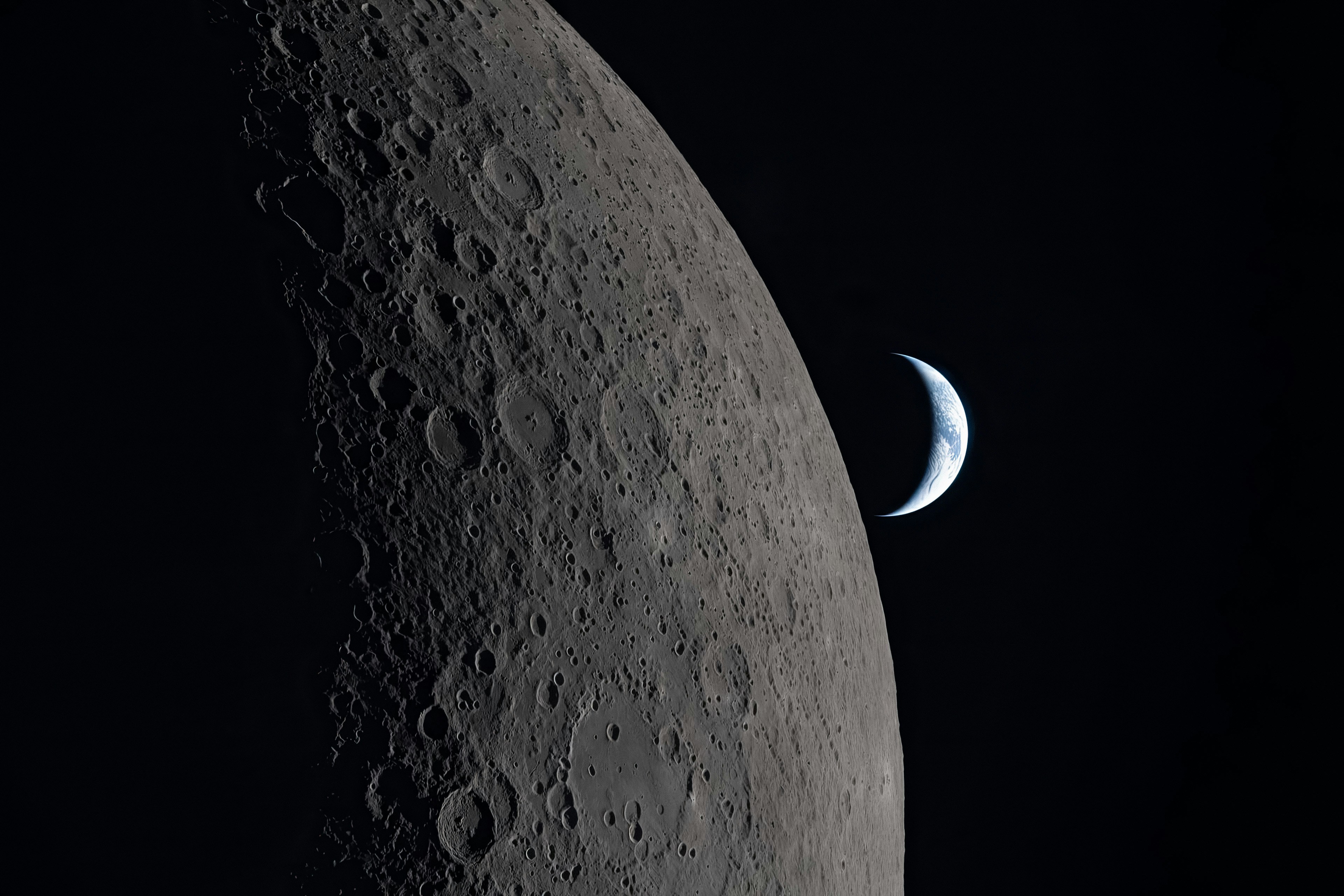 The moon and a sliver of earth in space