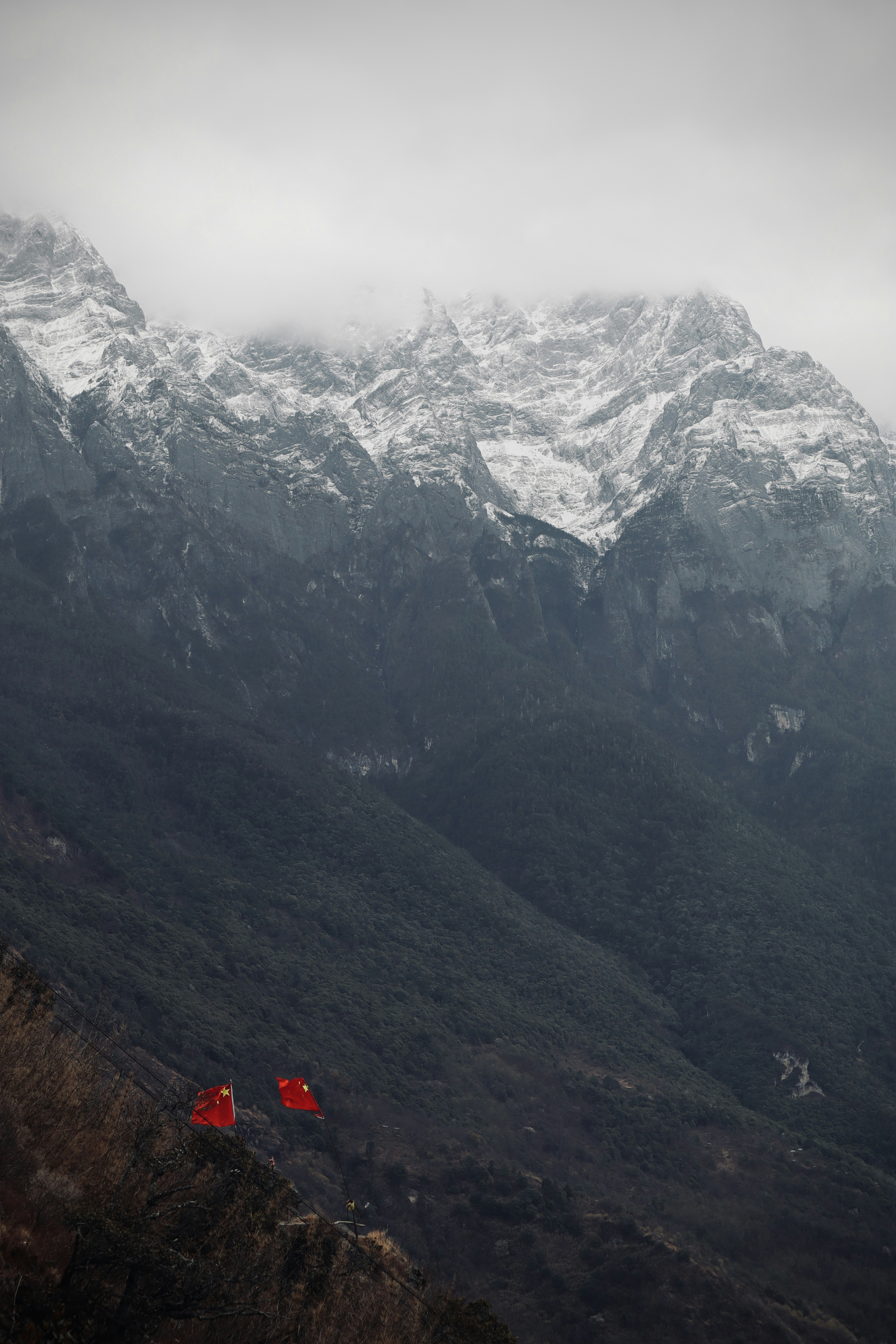 Chinese flags at Tiger Leaping Gorge, China.
