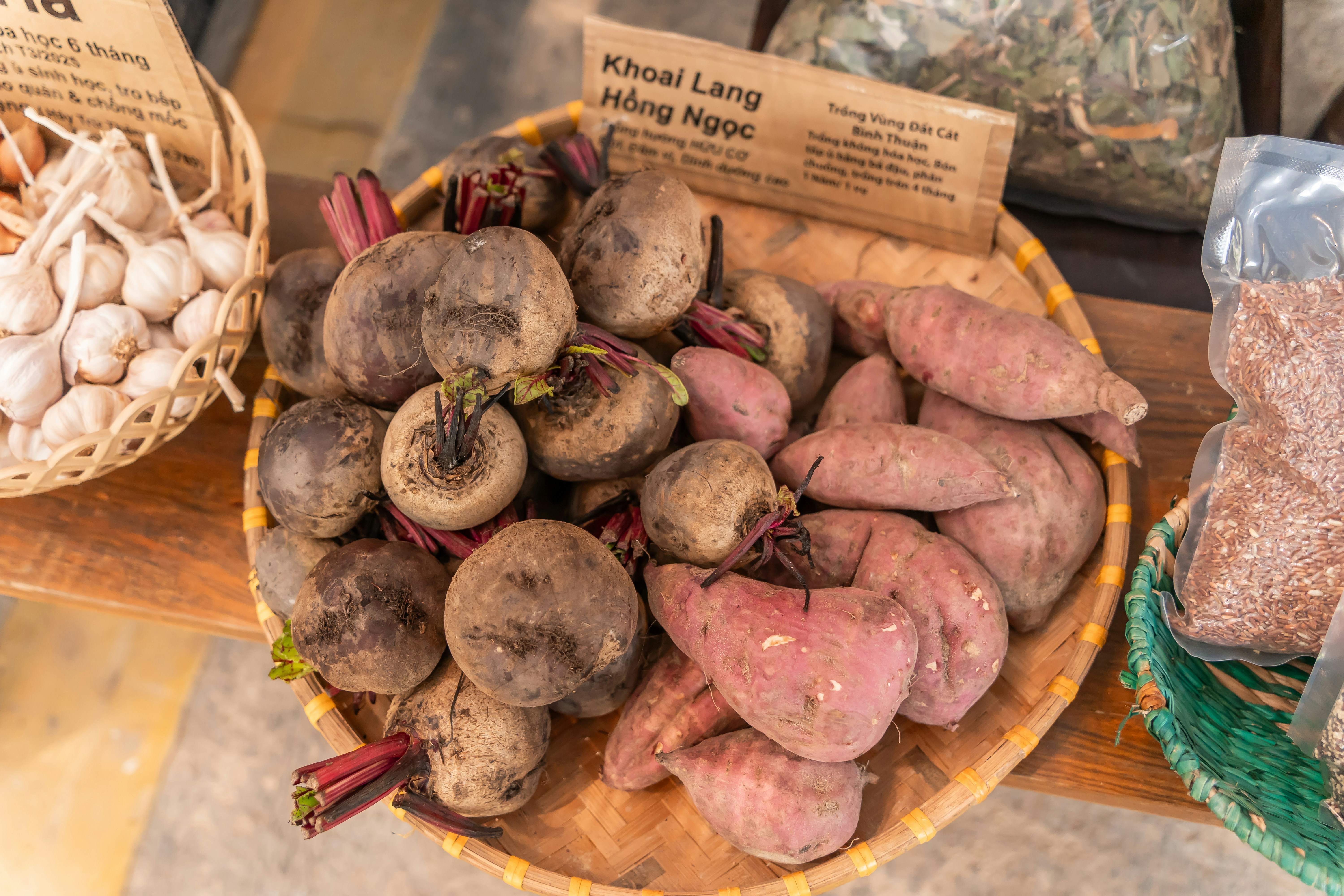 Fresh beets and sweet potatoes in a woven basket
