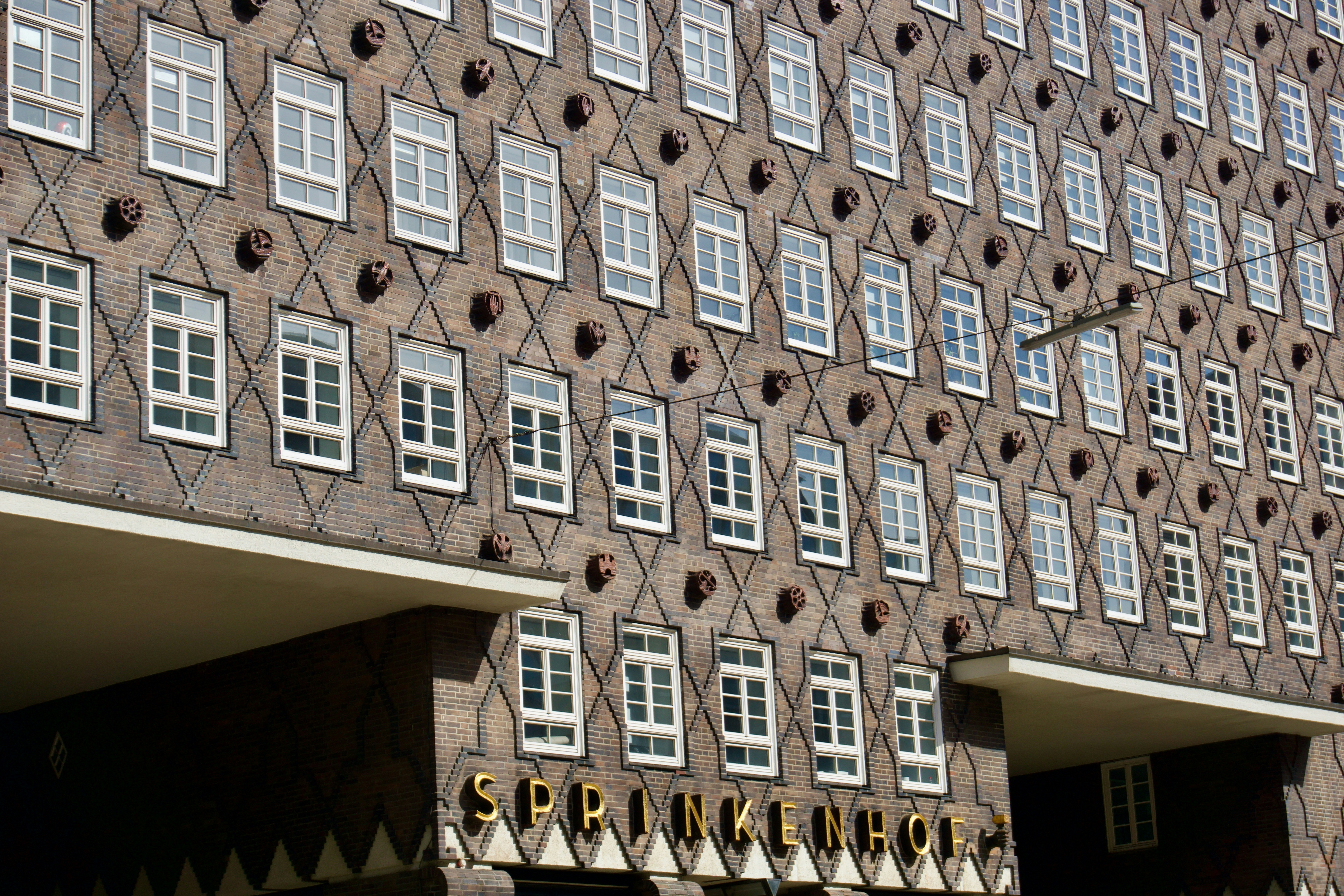 A building facade with many windows and geometric patterns.
