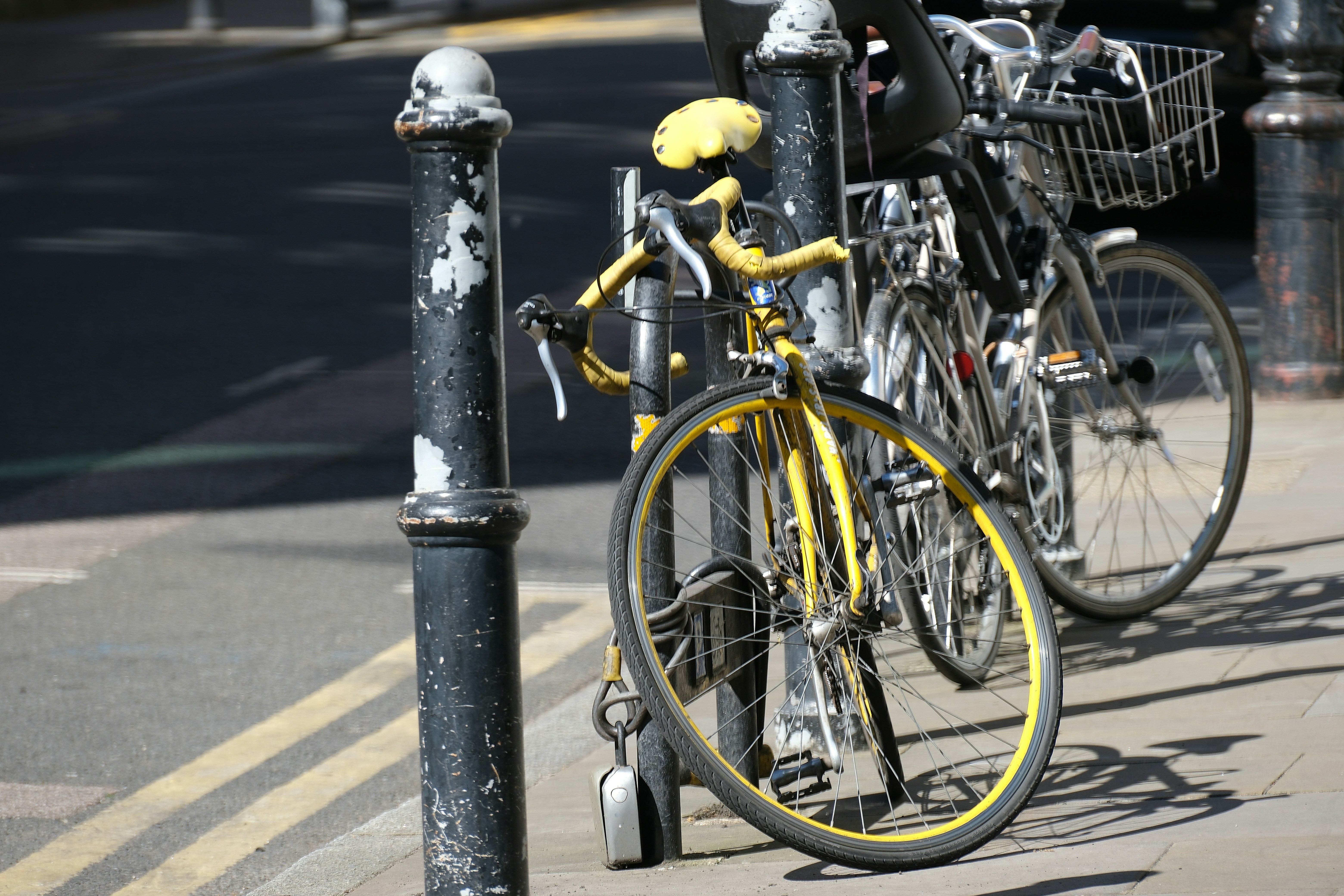 Yellow bicycle parked on a sunny street