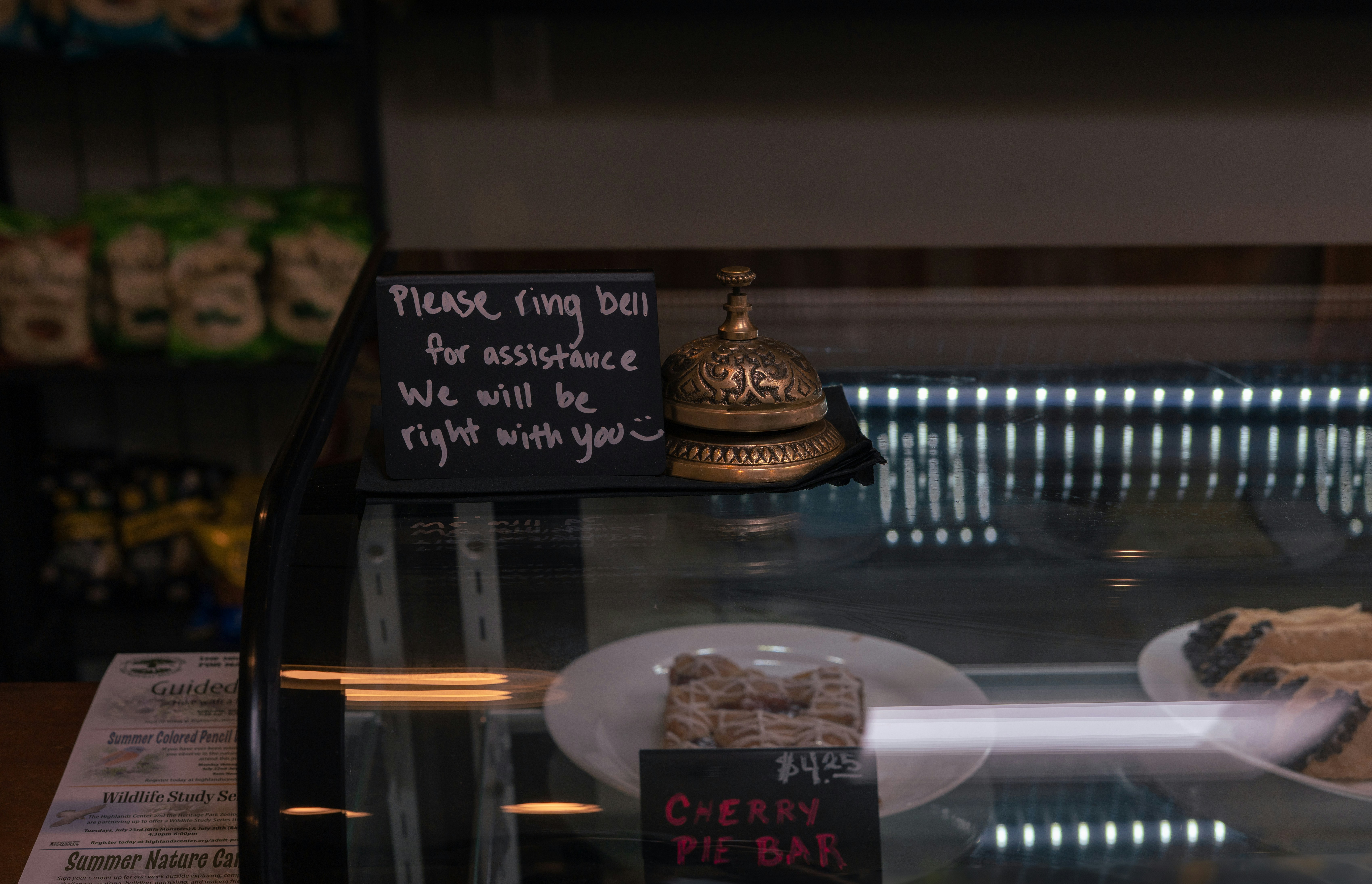 A bell and sign on a display case