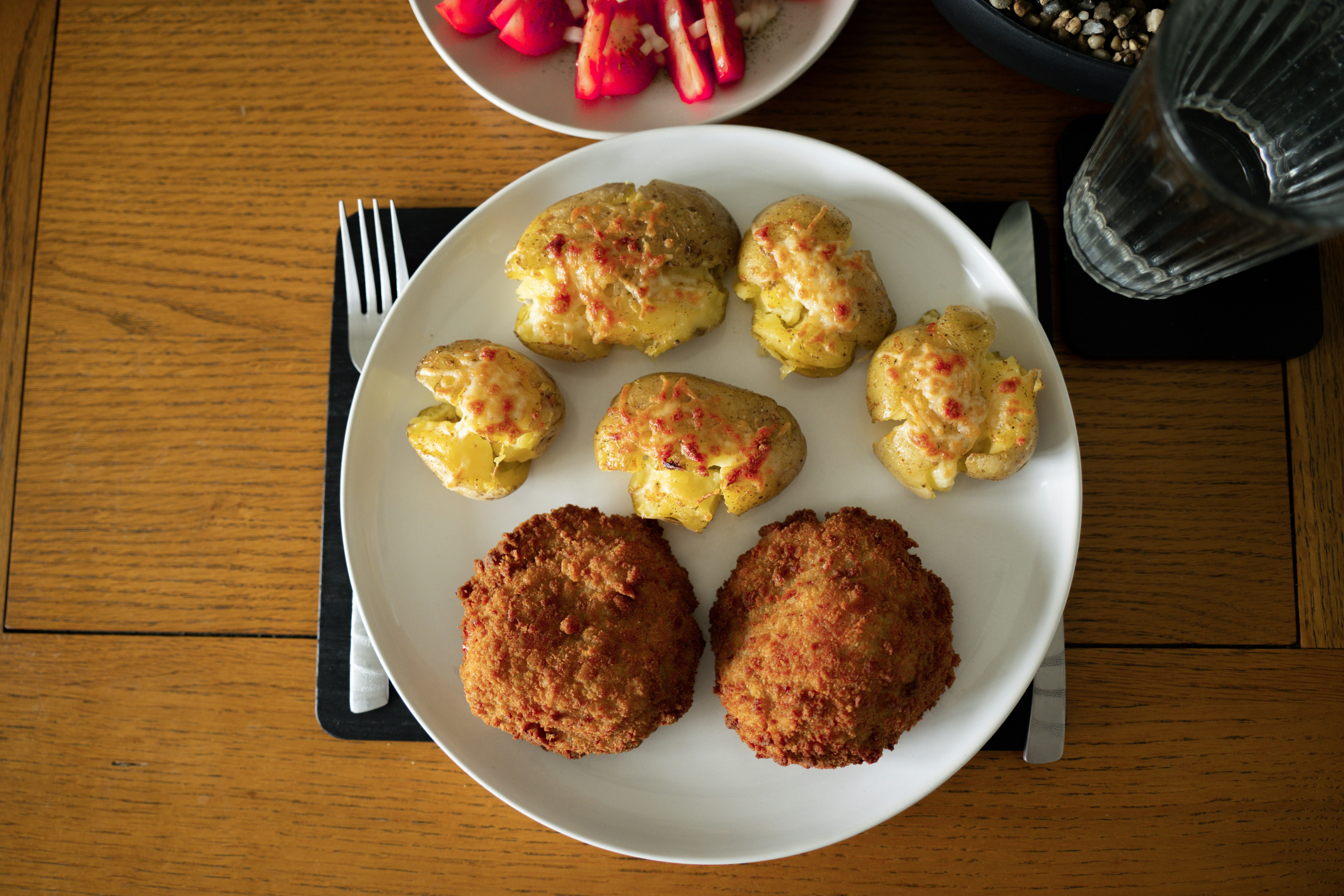 Plate of smashed potatoes and crispy chicken