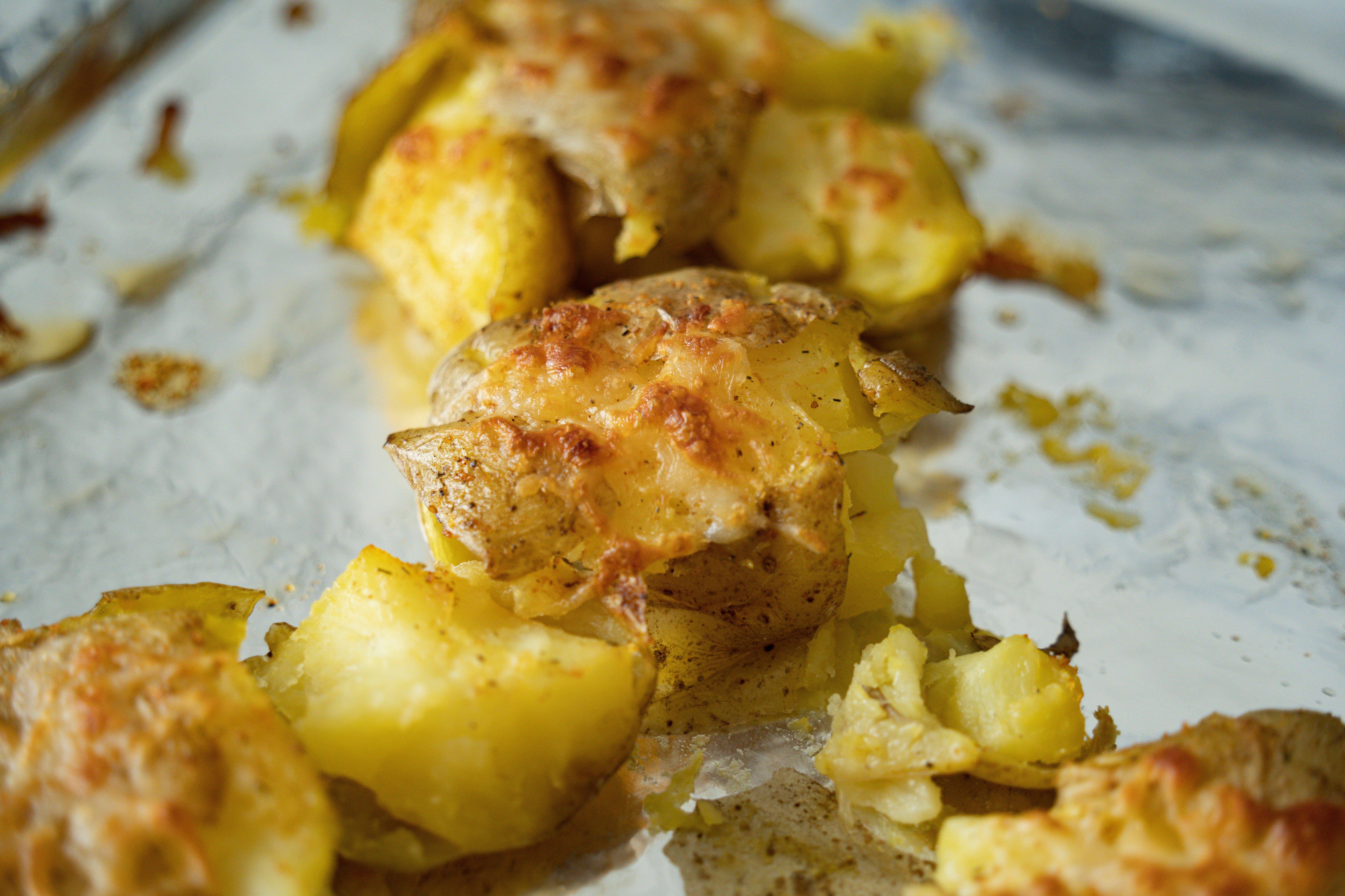Crispy baked potatoes with melted cheese