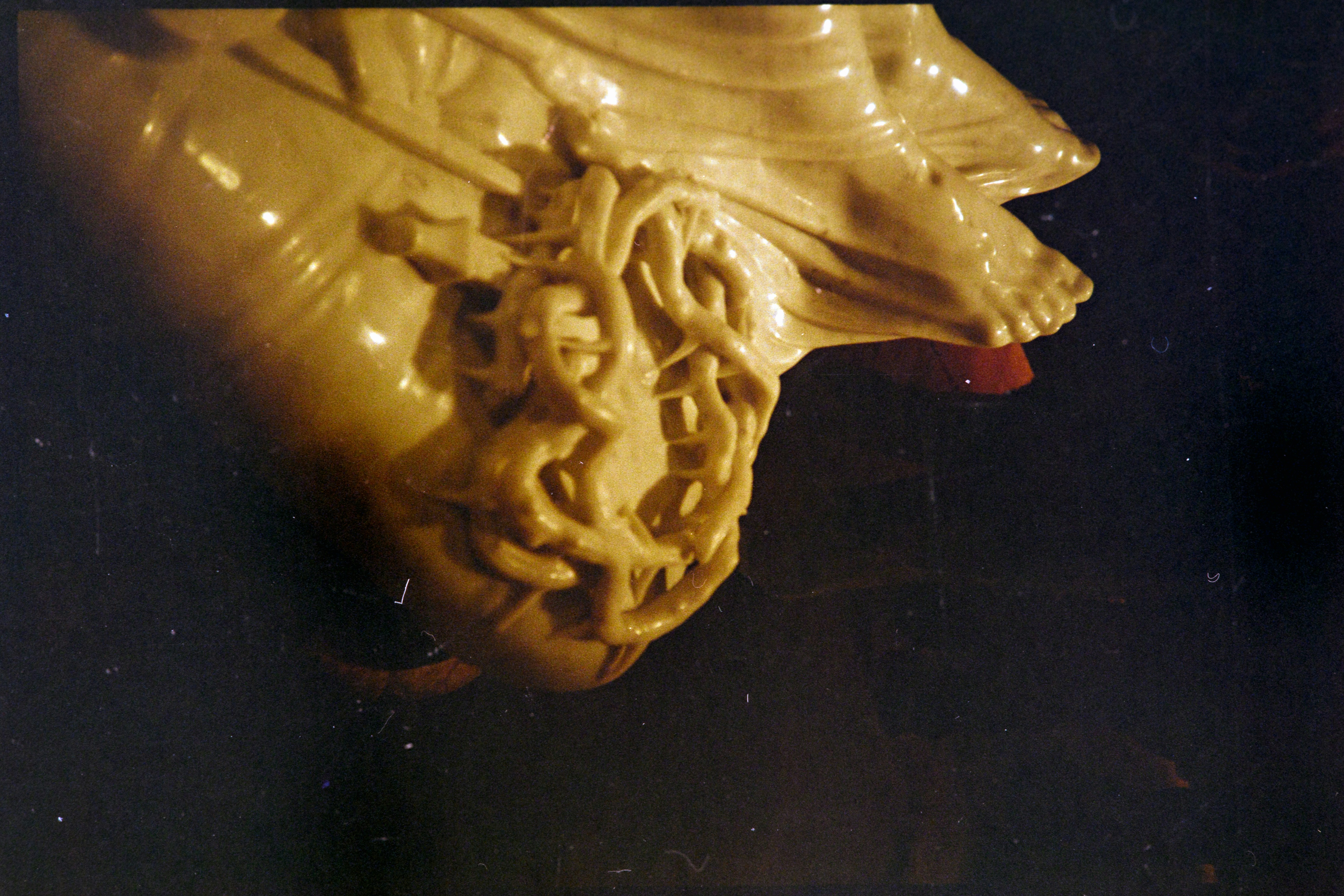 Close-up of a beige sculpture with intricate details.