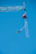 A person bungee jumping from a tall structure.
