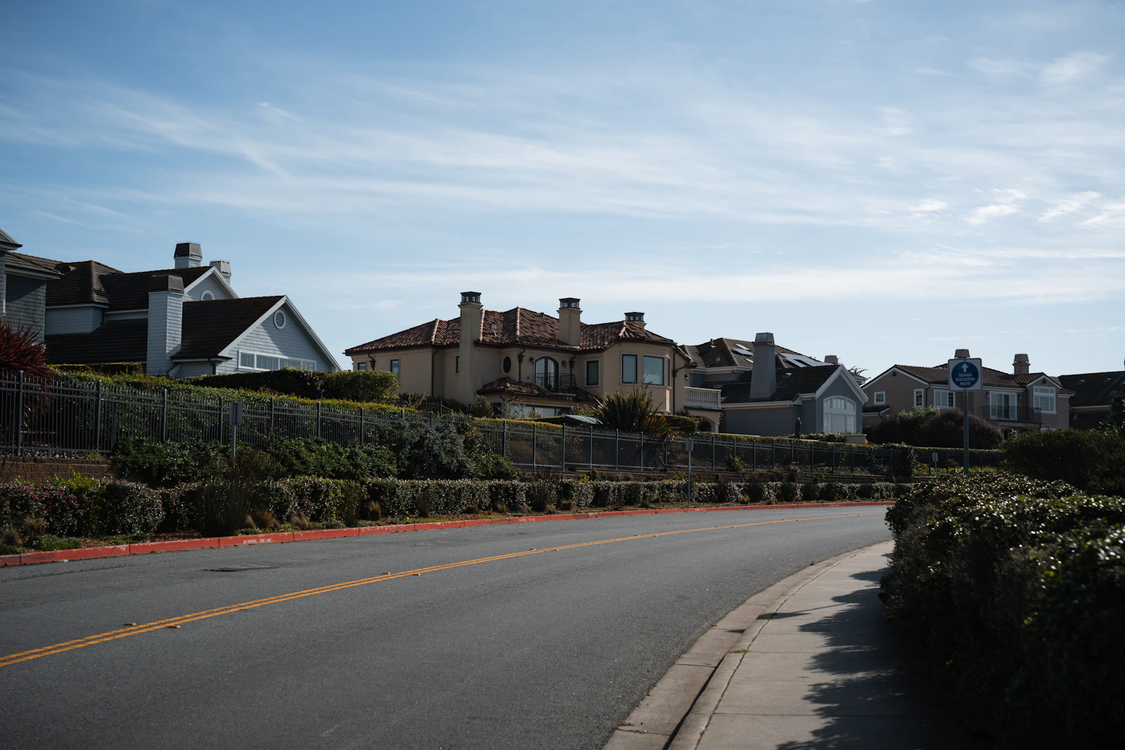Curving paved road through residential community