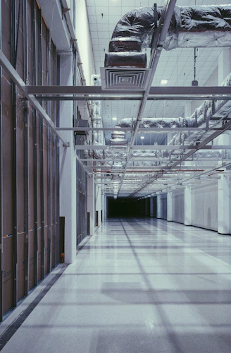 Long hallway with exposed pipes and ventilation systems