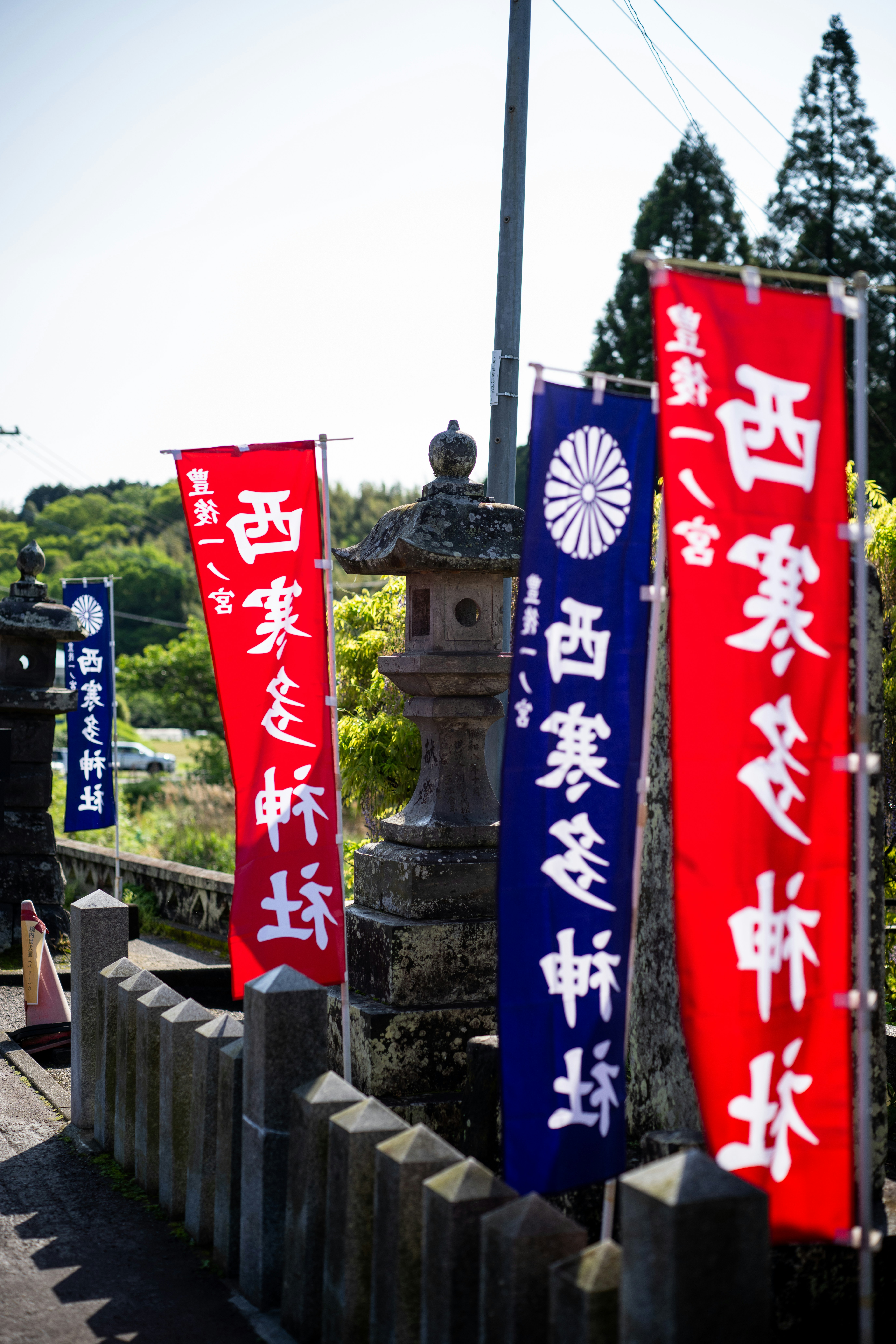 Red and blue banners with japanese writing stand tall.