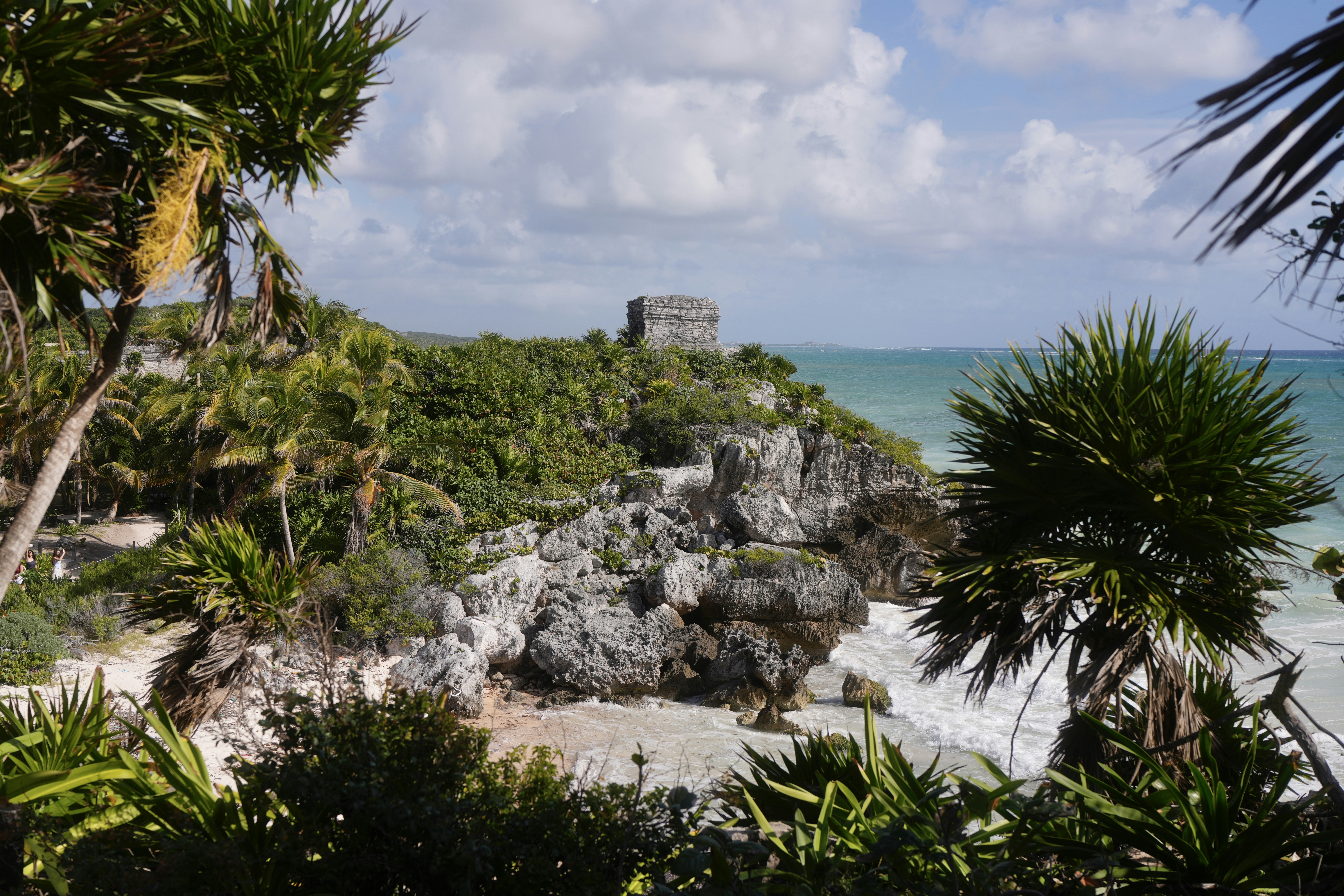 Ancient ruins on a cliff overlooking the ocean.