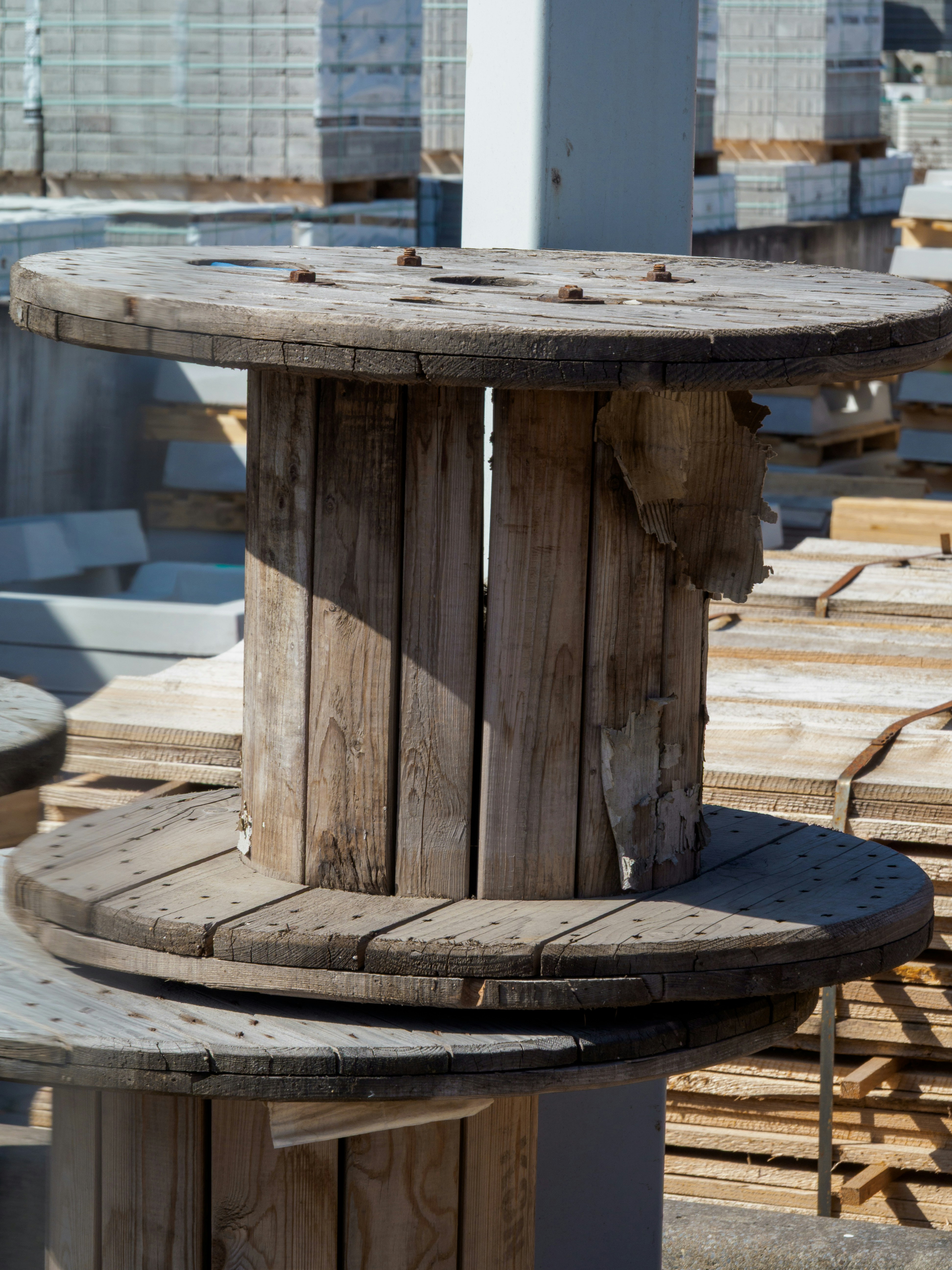 Two old wooden cable spools stacked outdoors