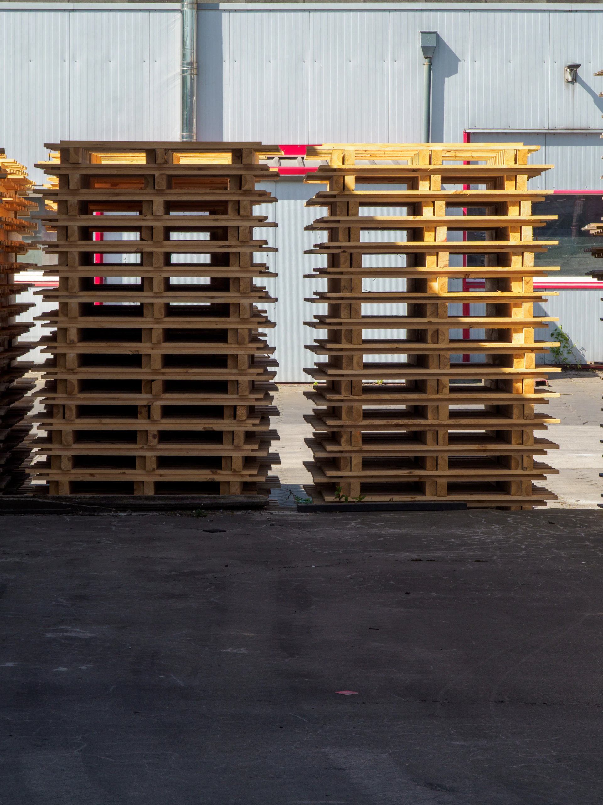 Stacks of wooden pallets outside a building