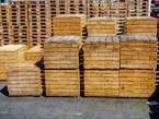 Stacks of wooden pallets in an outdoor storage area
