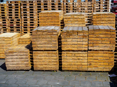 Stacks of wooden pallets in an outdoor storage area