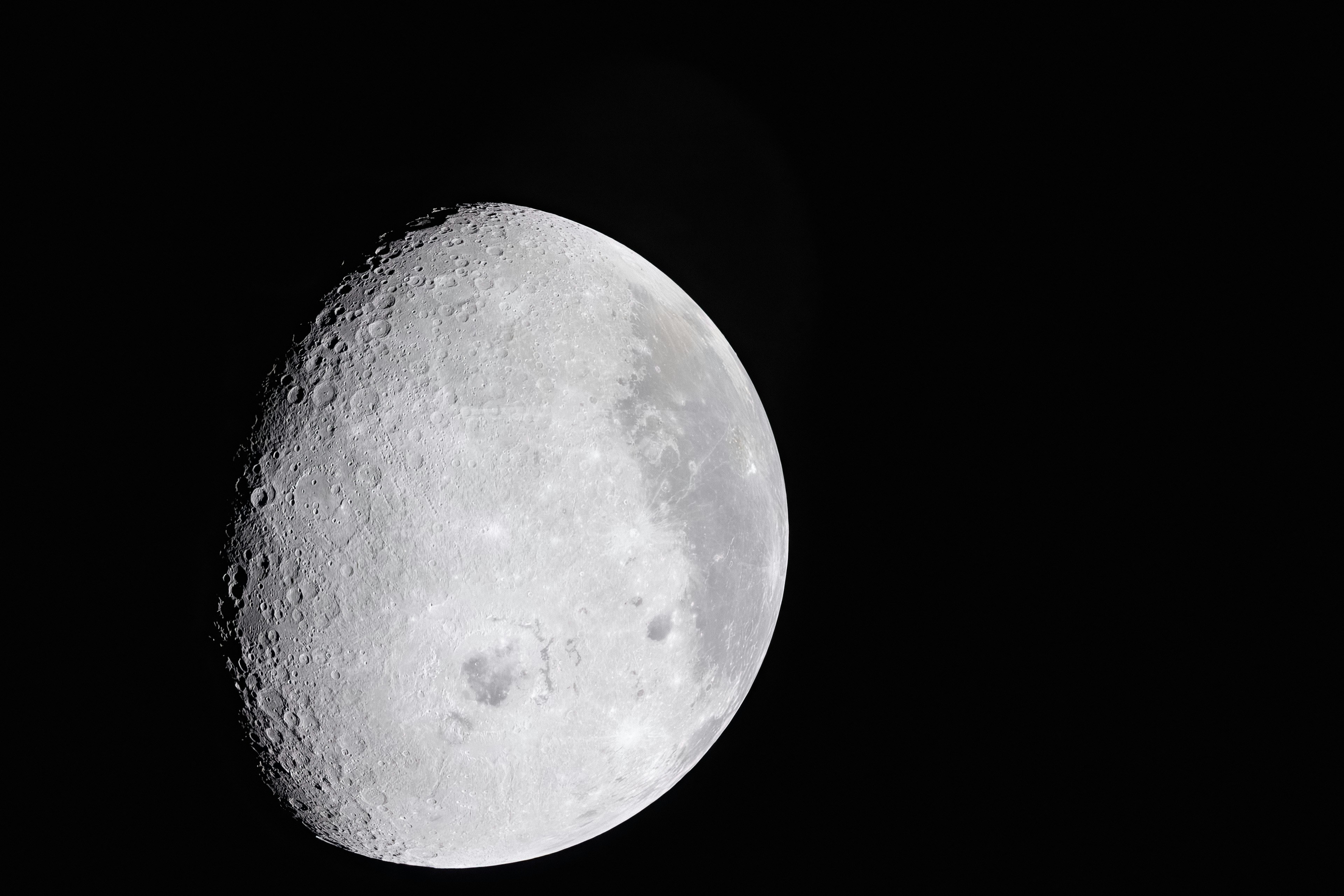 Dark Craters, Bright Views art002e009627 (April 6, 2026) – During the first shift of the lunar flyby observation period, the Artemis II crew captured more than two-thirds of the Moon, highlighting surface details on the nearside, including the 600-mile-wide impact crater, Orientale basin, along the boundary between the near and far sides. They also captured the Grimaldi crater, a dark, round feature northeast of Orientale, known for its dark mare lava floor and heavily worn rim. Credit: NASA Image Credit: NASA