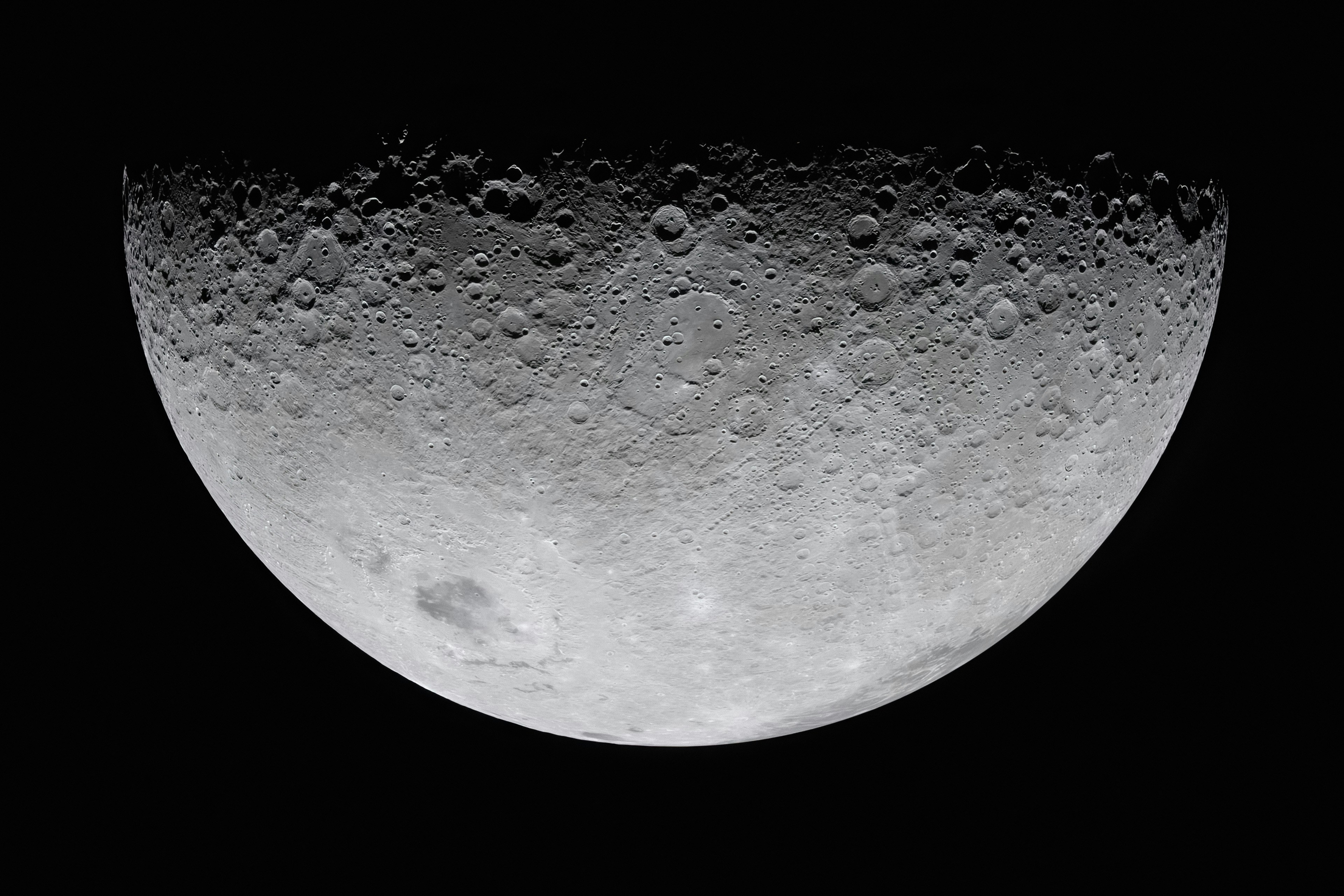 Crescent moon with visible craters against black background