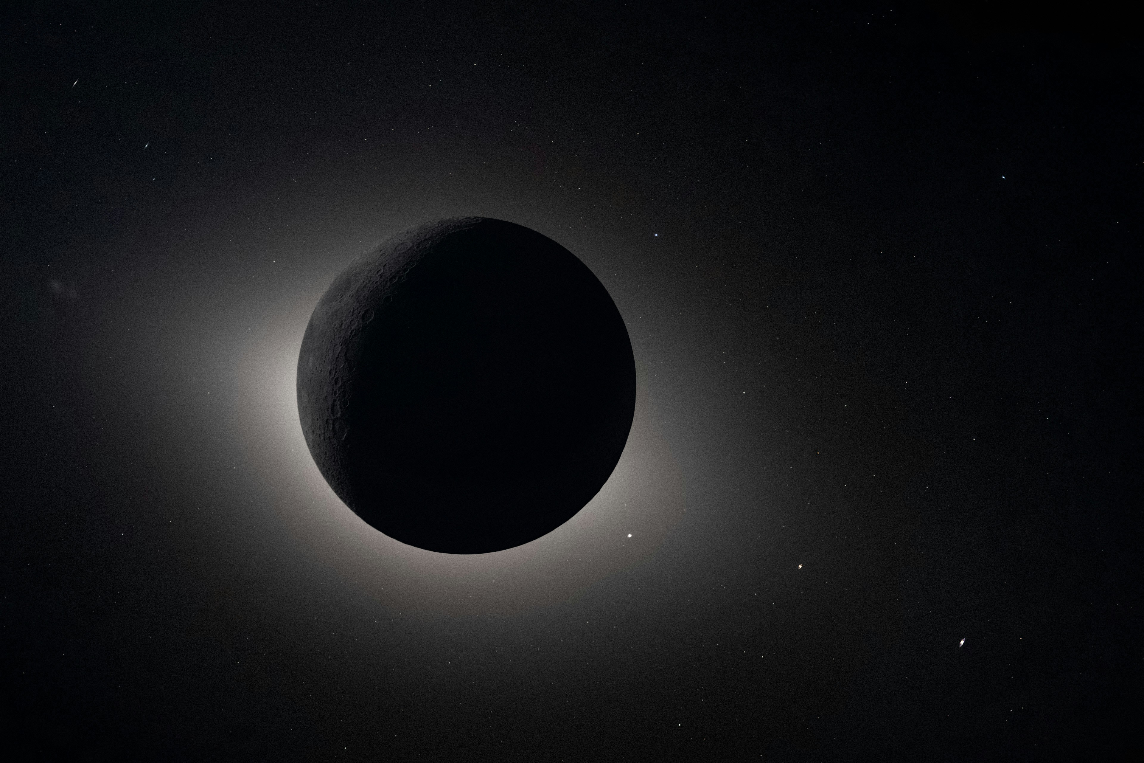 宇宙に明るい後光が浮かぶ暗い惑星。