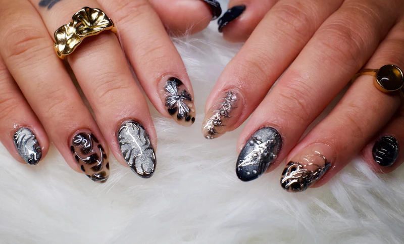 Long nails with a black-and-silver chrome-foil finish